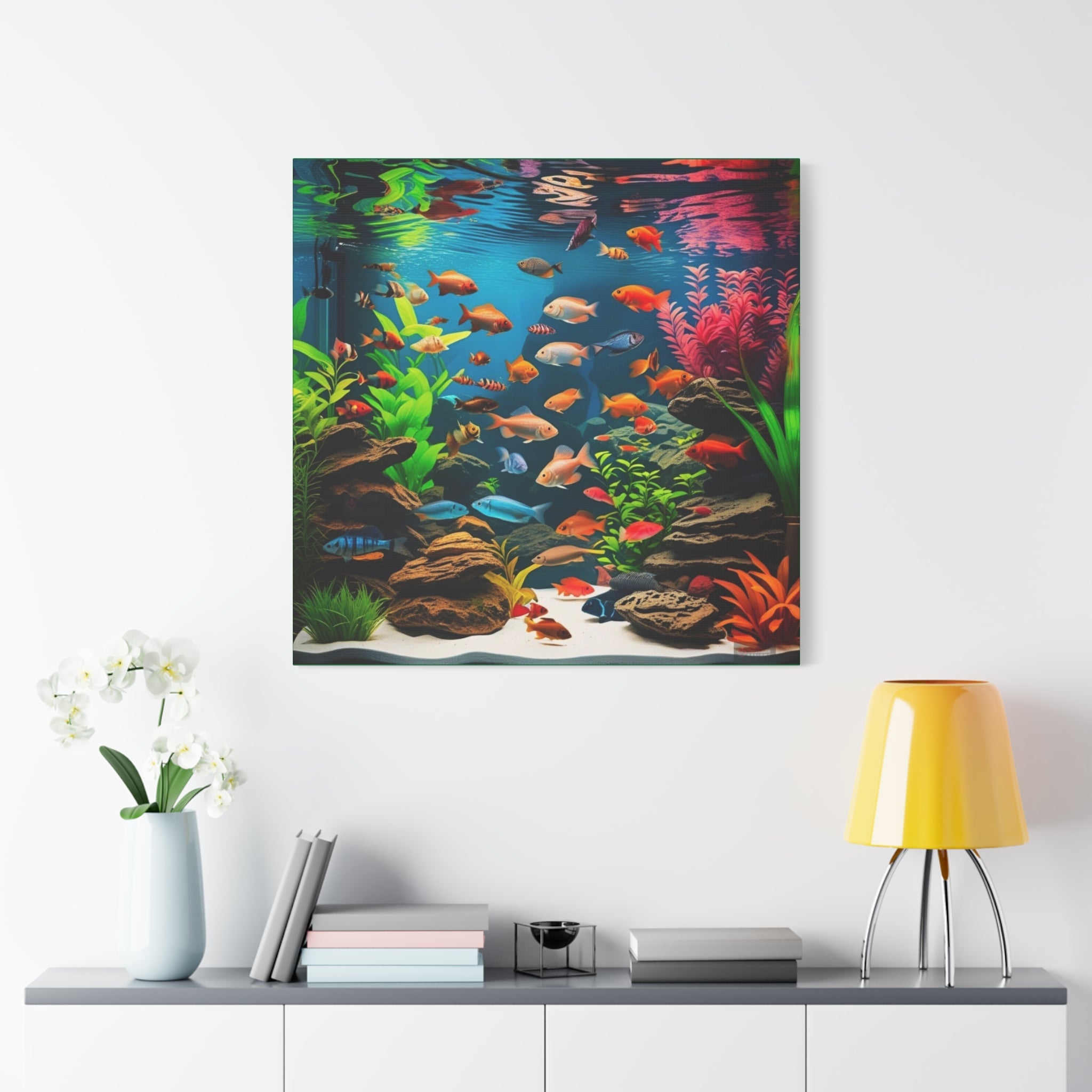 Framed artwork of a colorful aquarium scene with fish and plants on a wall above a shelf.