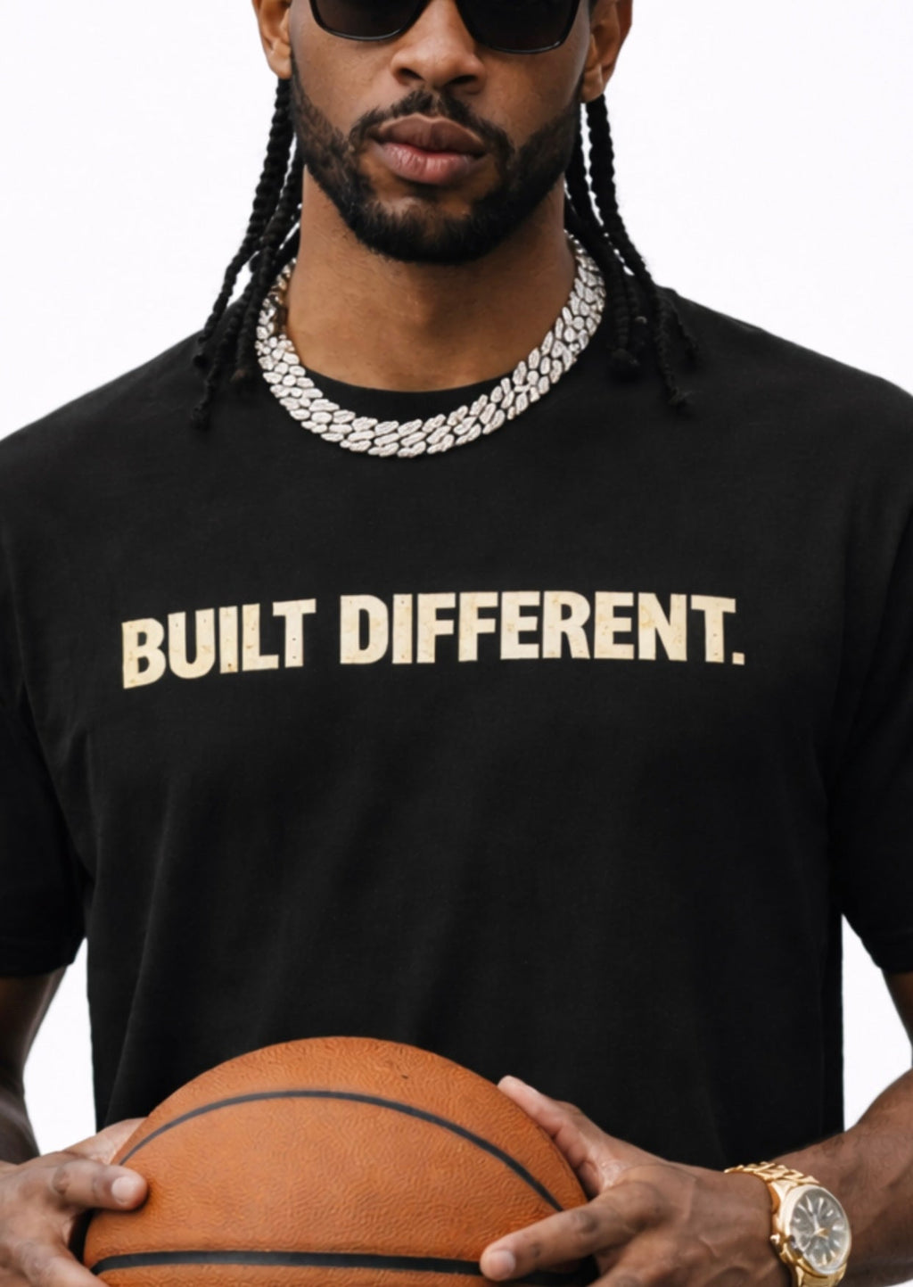 Man wearing a black t-shirt with text 'BUILT DIFFERENT.' holding a basketball by Relatable Designs
