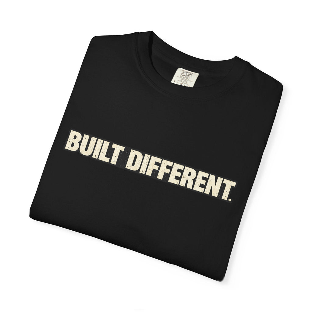 Folded black t-shirt with off white text 'Built Different' on a white background