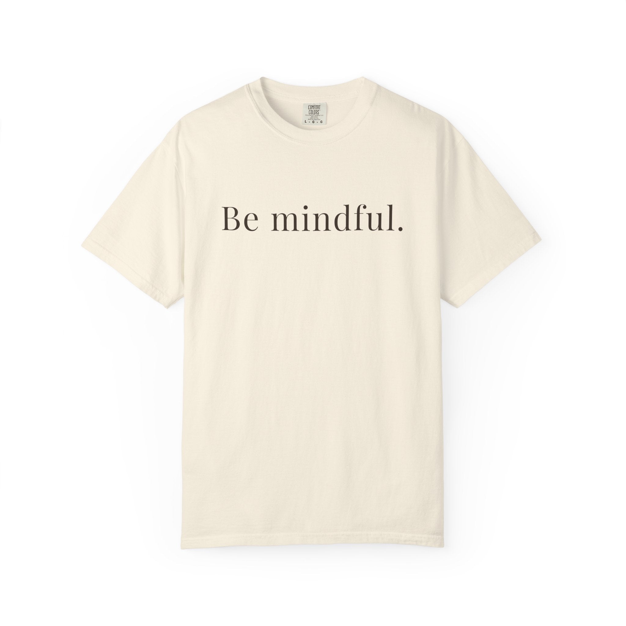 Beige t-shirt with 'Be mindful.' text on a white background