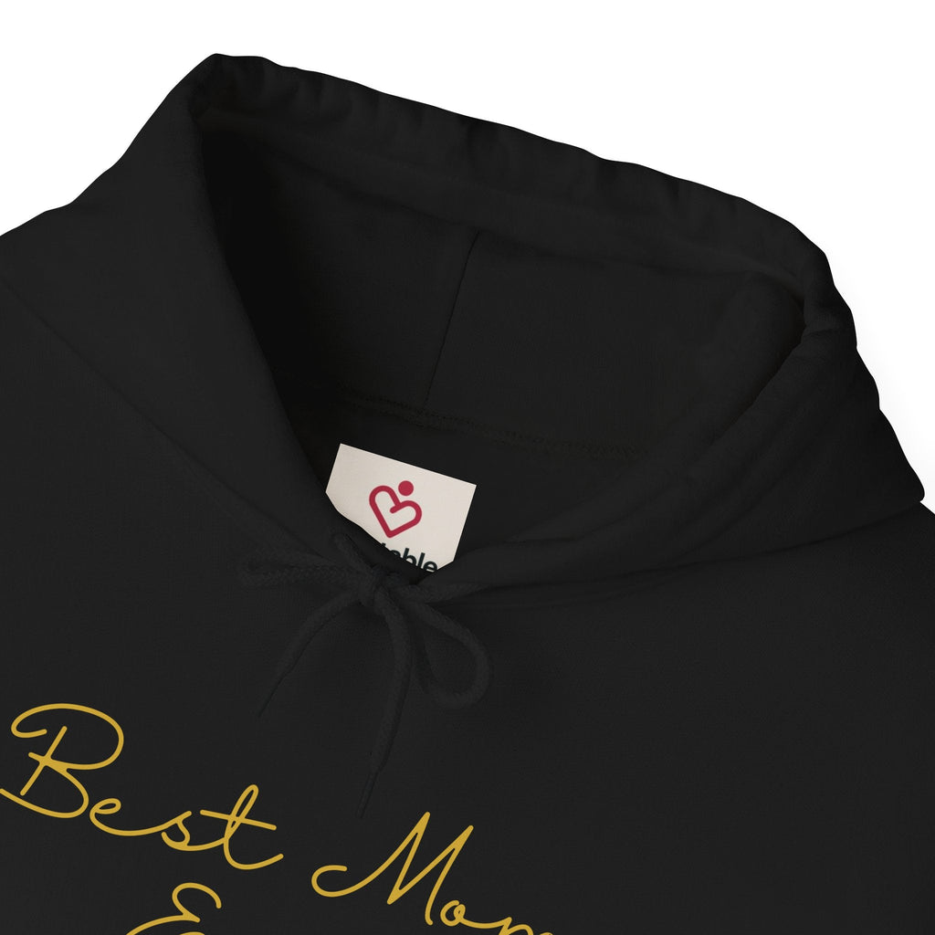 Black hoodie with 'Best Mom' text and a visible brand label on a white background