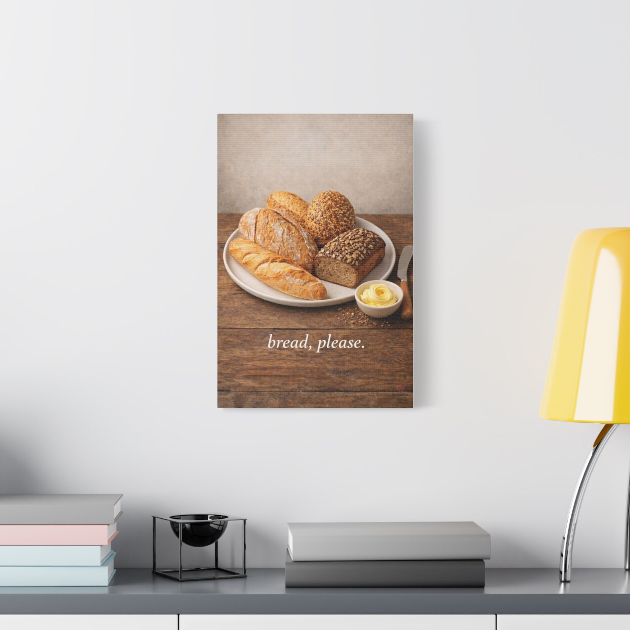 Canvas print of bread on a wooden table with 'bread, please' text, displayed on a wall above a desk. 20X30
