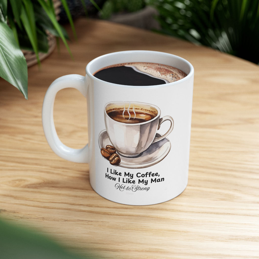 Humorous white ceramic mug with quote on wooden desk. Left view