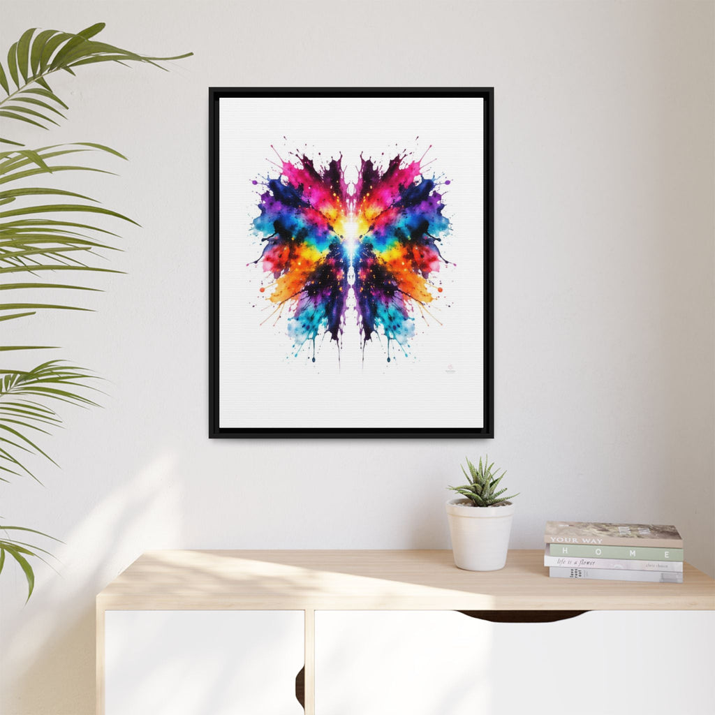 Framed artwork of colorful inkblot abstract on a wall above a desk with a plant and books - 24X30