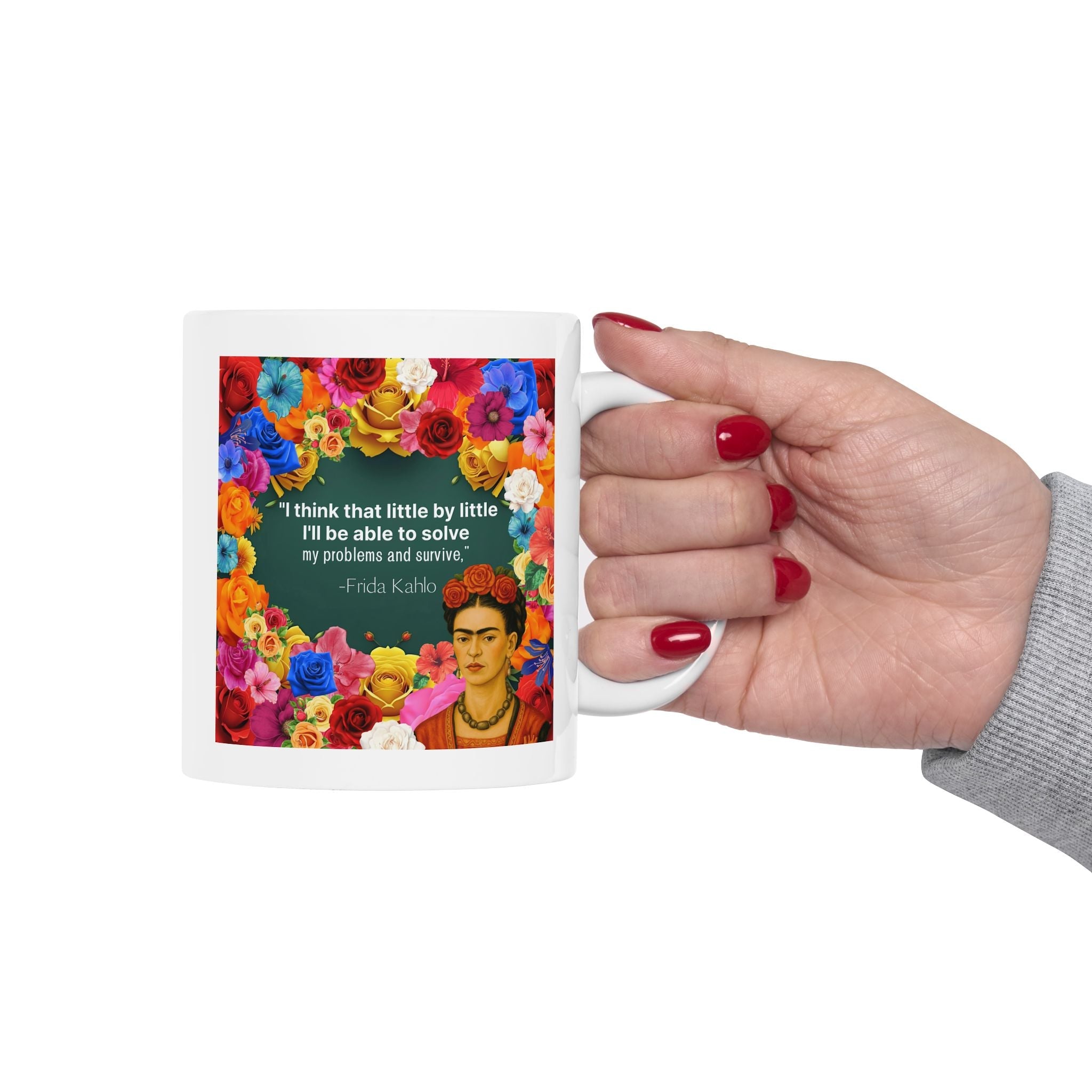 Colorful Floral Mug with Frida Kahlo design and quote, held by a hand with red nails.