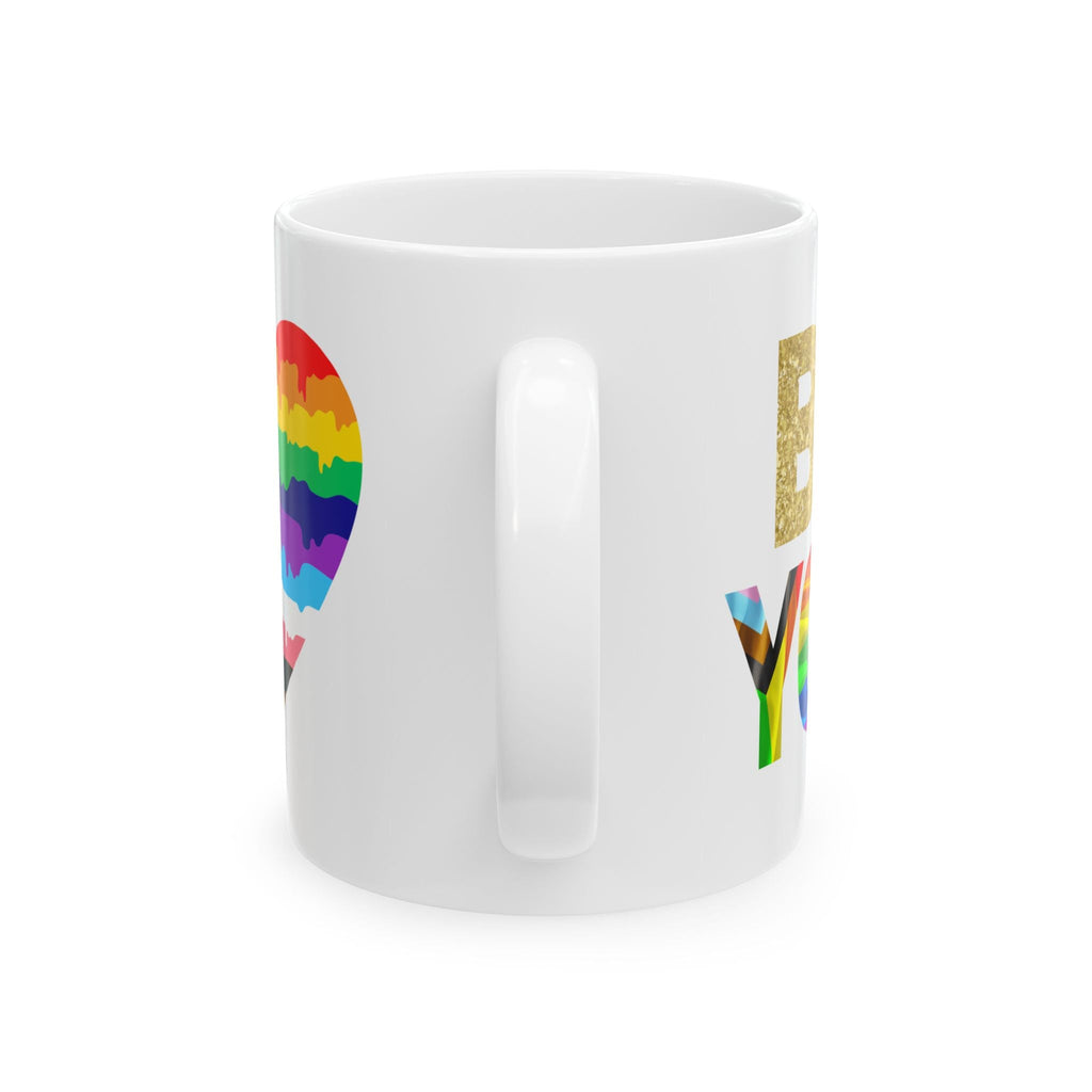 White mug with 'Be YOU Unapologetically' quote and rainbow heart on a white background. Side View.