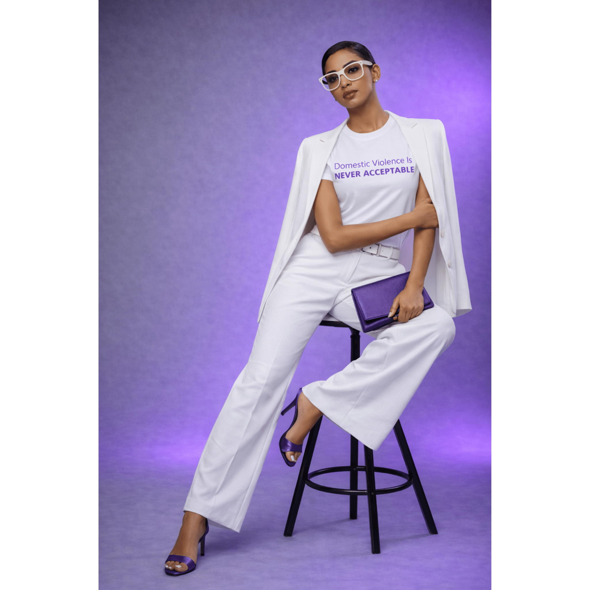Editorial model seated wearing domestic violence awareness t-shirt in studio setting