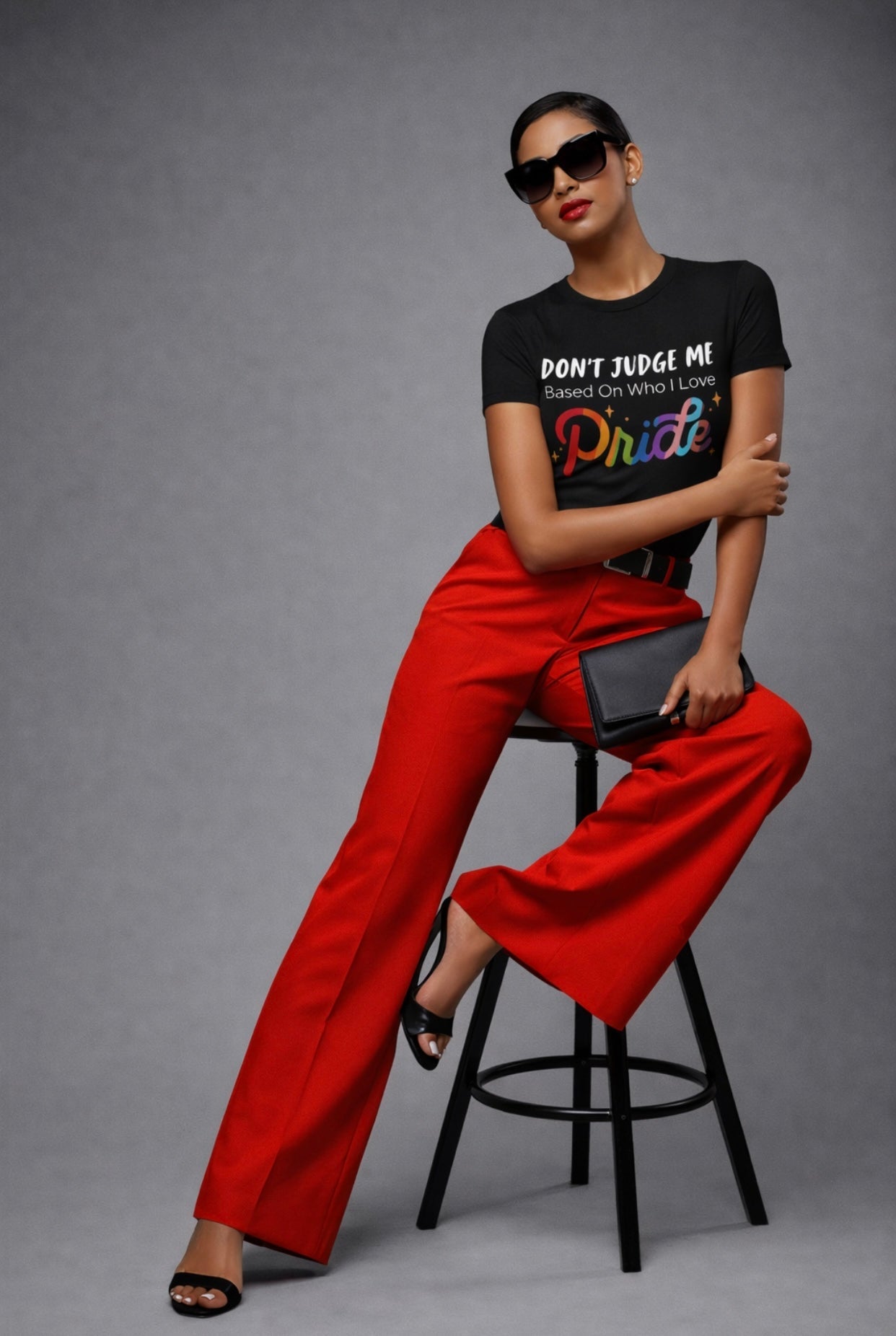 Relatable Designs black "Don't Judge Me – Pride" rainbow graphic t-shirt styled with red pants bold outfit fashion mock up 