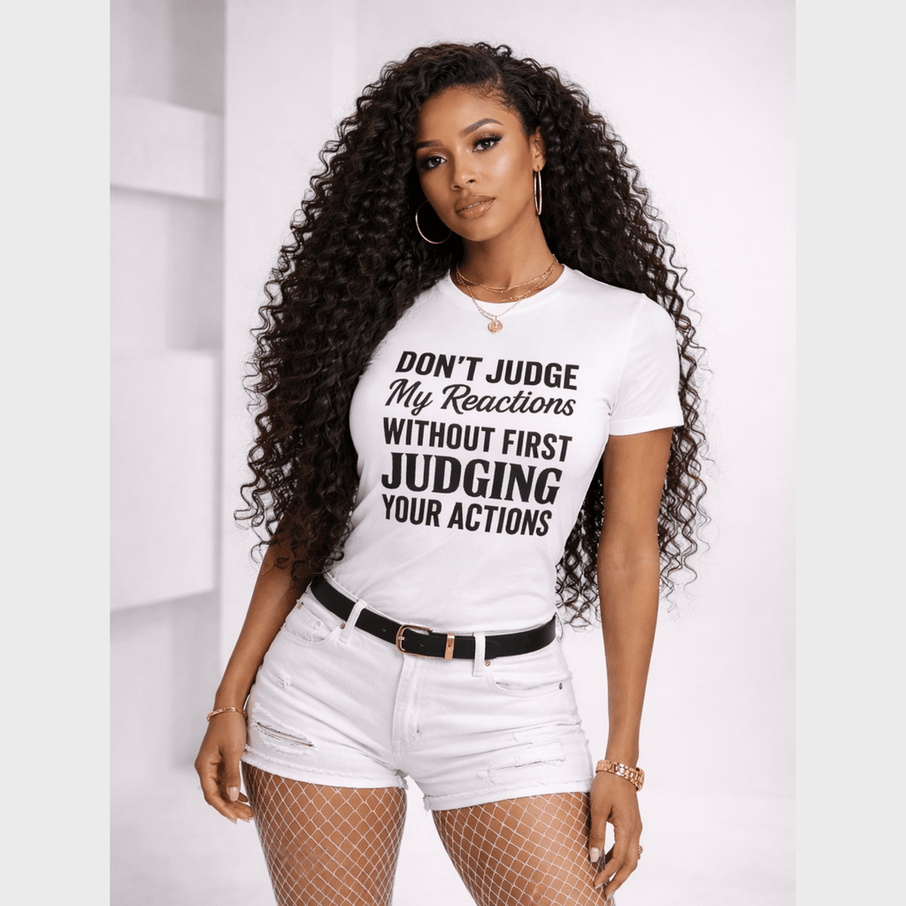 Woman wearing statement graphic t-shirt with bold quote, styled with white shorts, confident fashion look by Relatable Designs