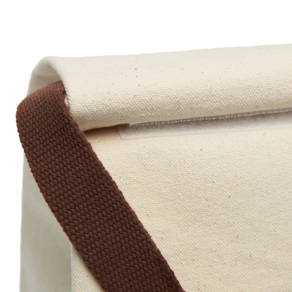 Close-up of beige fabric with brown trim on a white background for Save The Planet lunch tote bag
