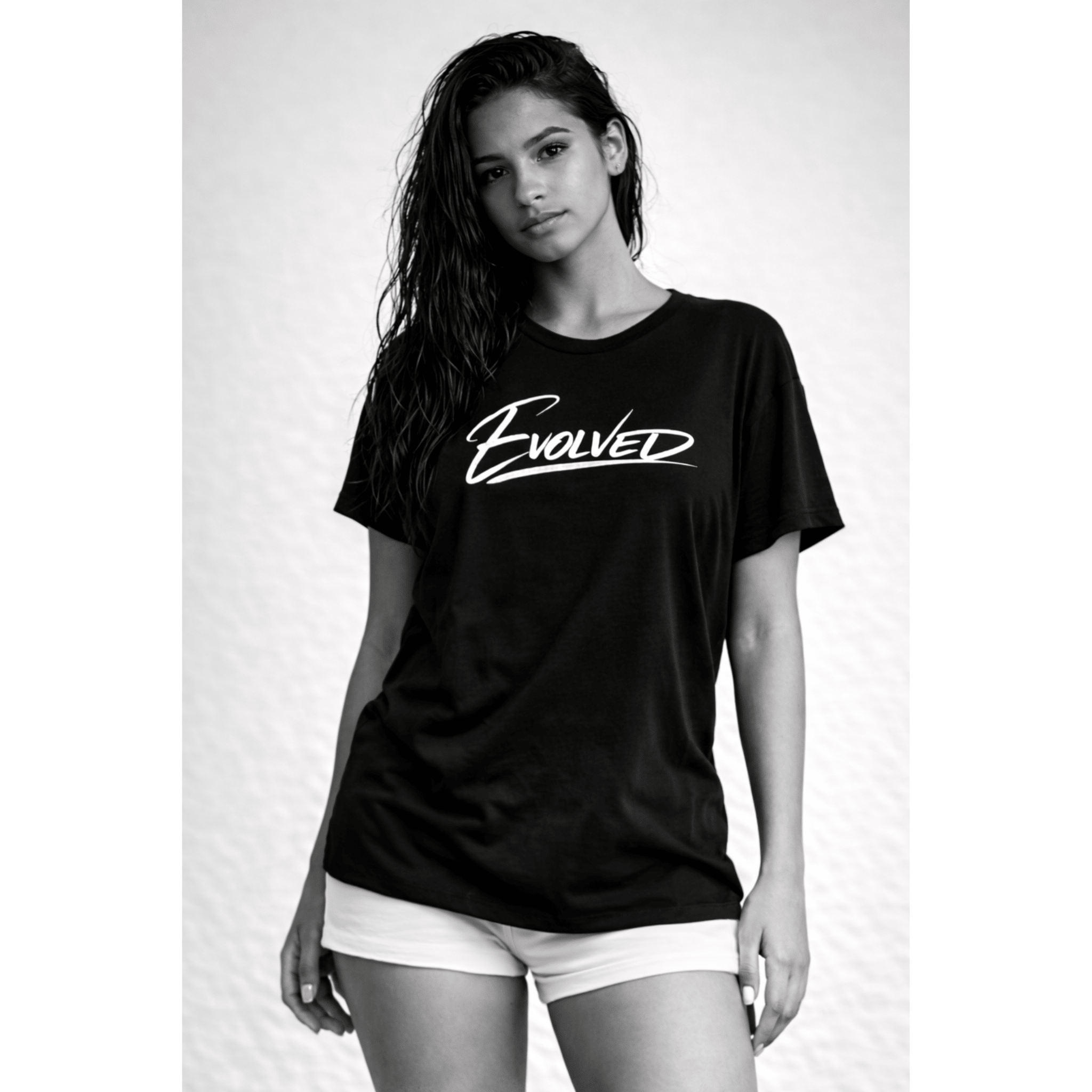 Black "Evolved" t-shirt on female model, minimal monochrome editorial style by Relatable Designs