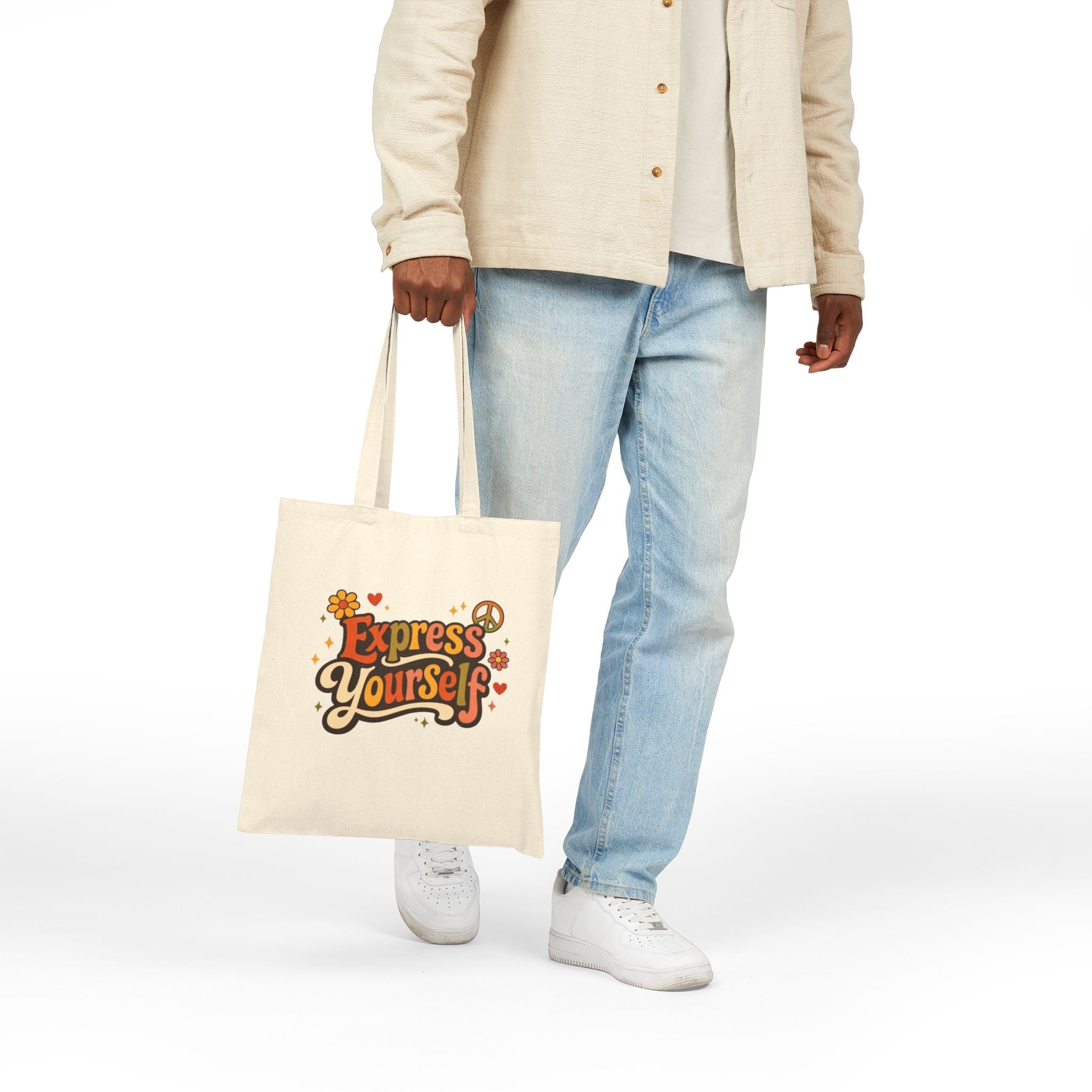 Person holding a tote bag with 'Express Yourself' text on a white background