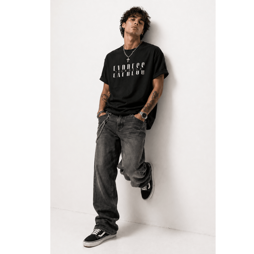 Man wearing a black t-shirt with white text 'Express Yourself' and gray jeans against a white background