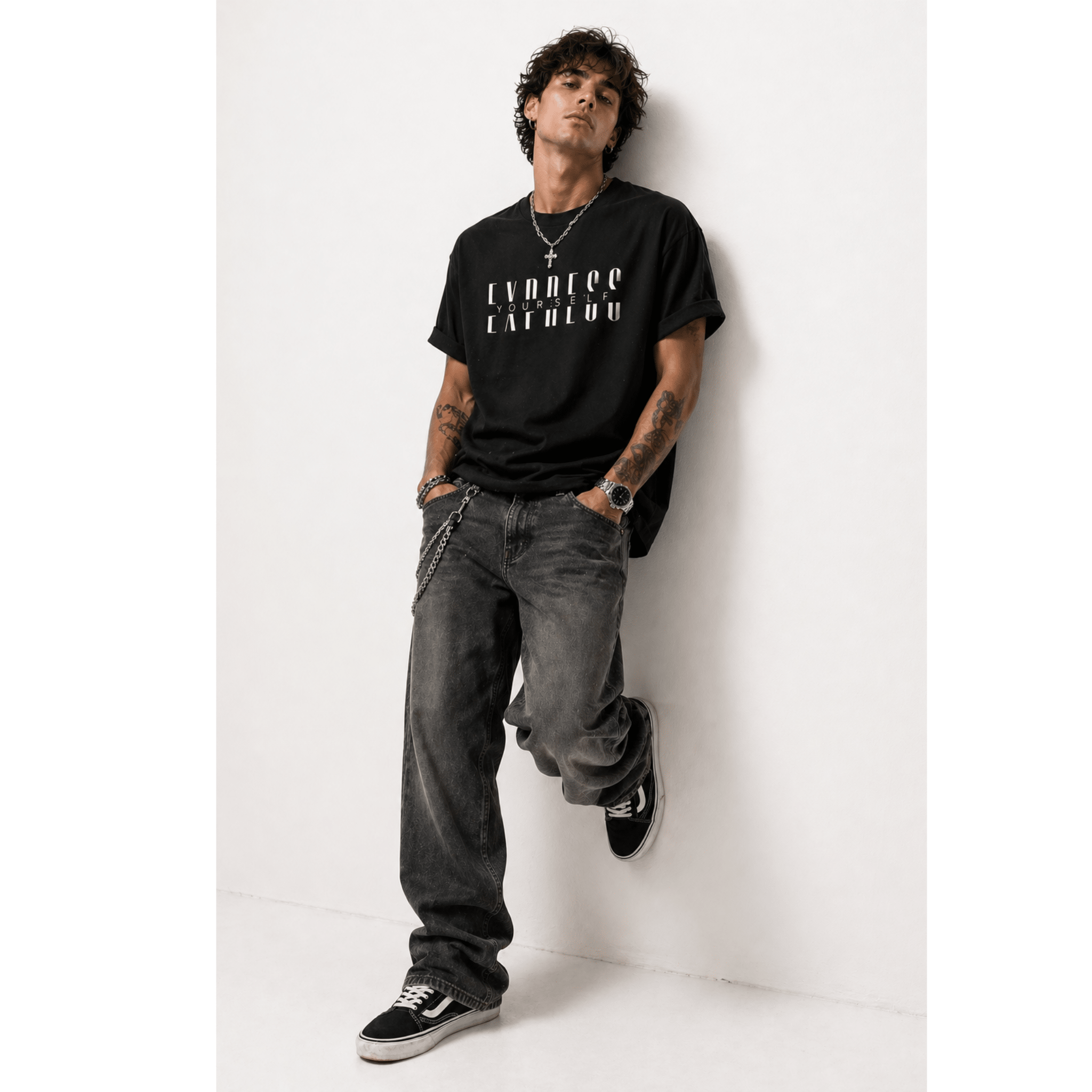 Man wearing a black t-shirt with white text 'Express Yourself' and gray jeans against a white background