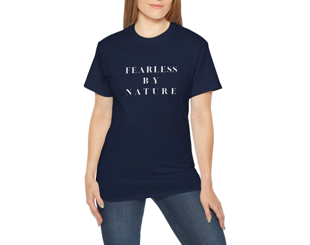 Person wearing a navy blue t-shirt with 'FEARLESS BY NATURE' text on a white background by Relatable Designs.