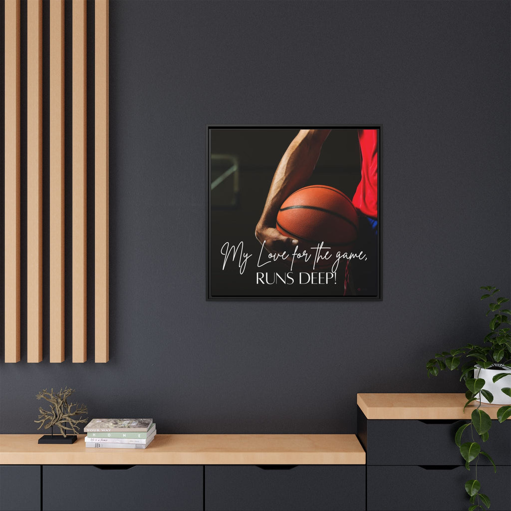 Framed motivational wall art of a man's hand holding a basketball with text on a dark wall.