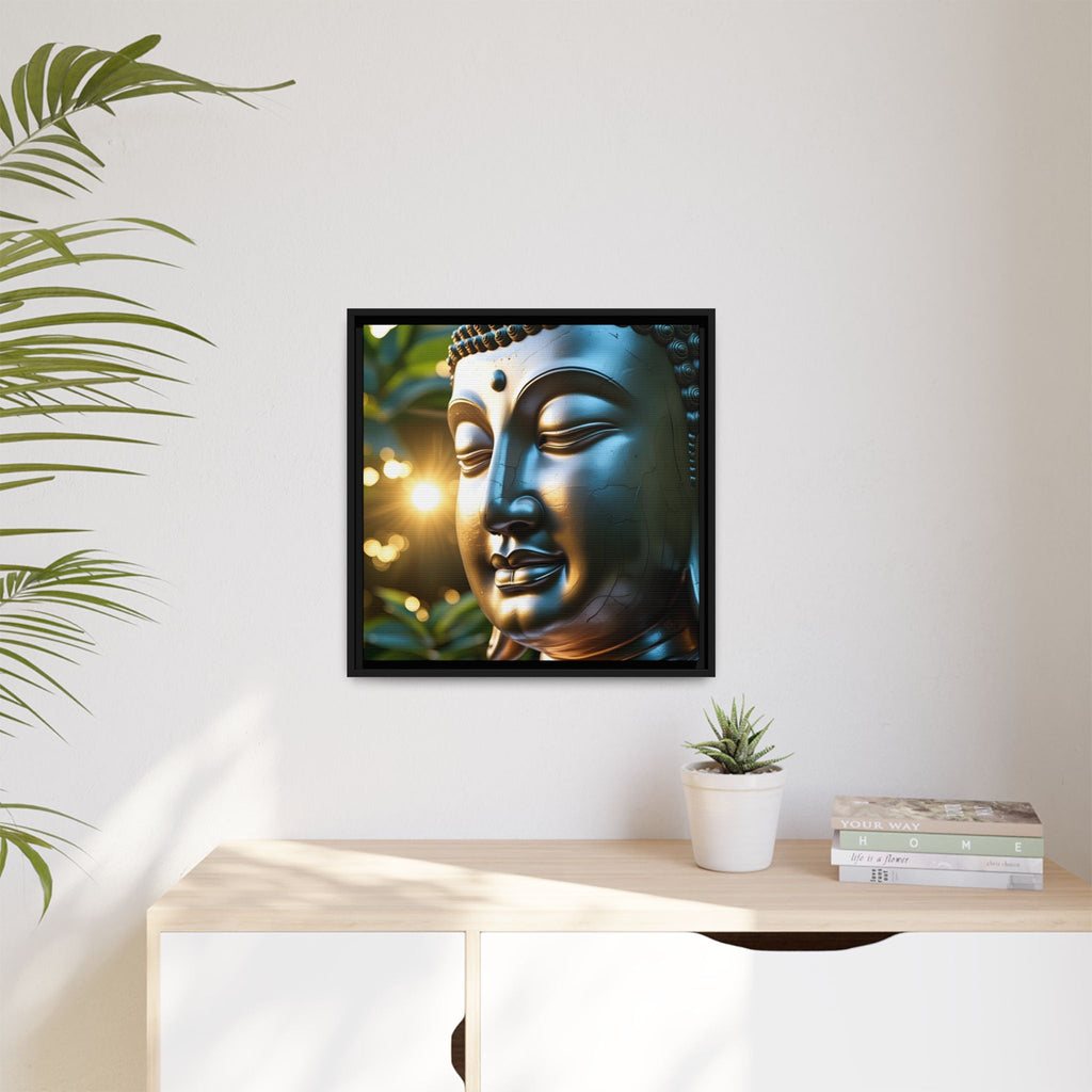 Framed artwork of a Buddha's face on a wall above a desk with a plant and books.