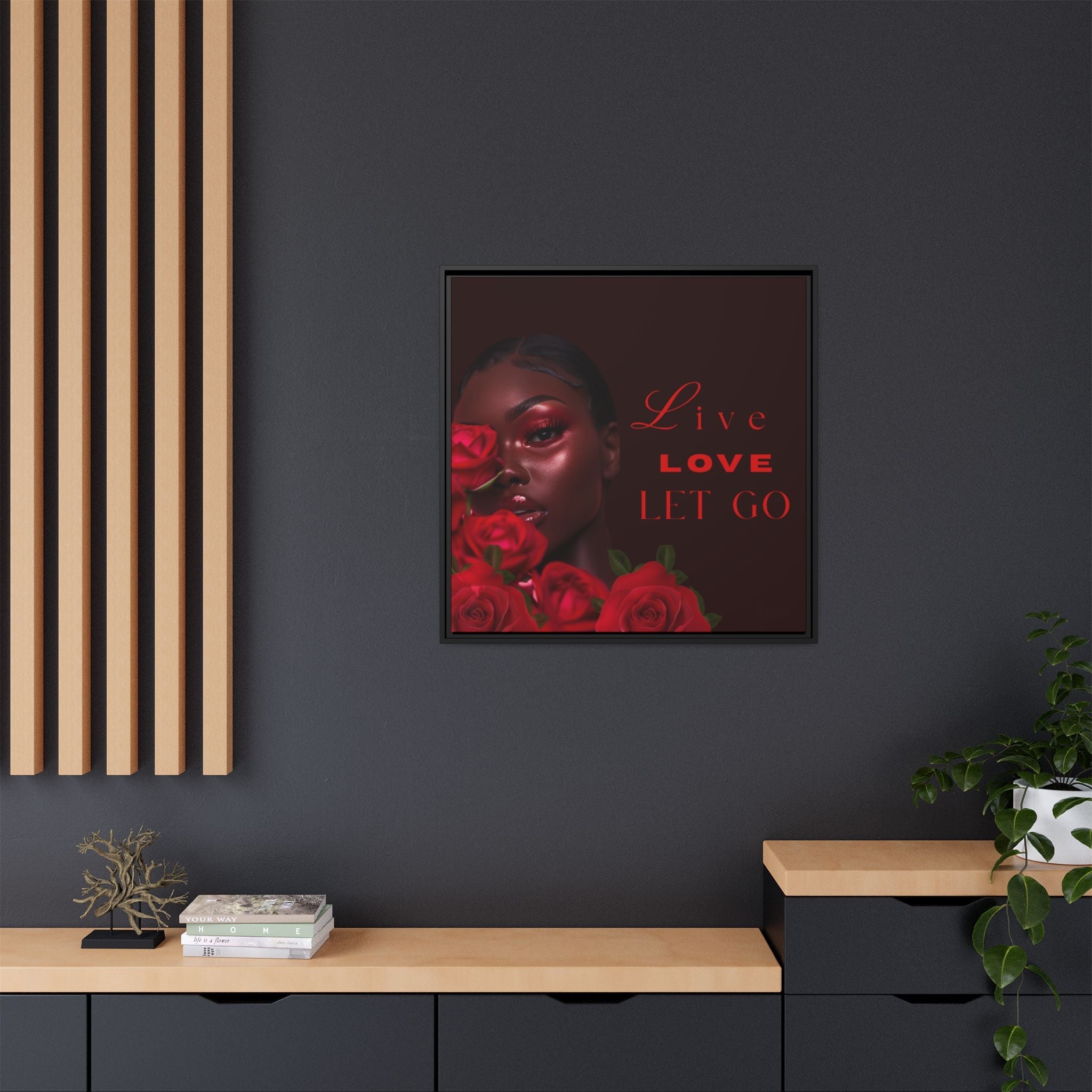 Modern artwork with a woman's face and red roses on a dark wall, with 'Live Love Let Go' text.