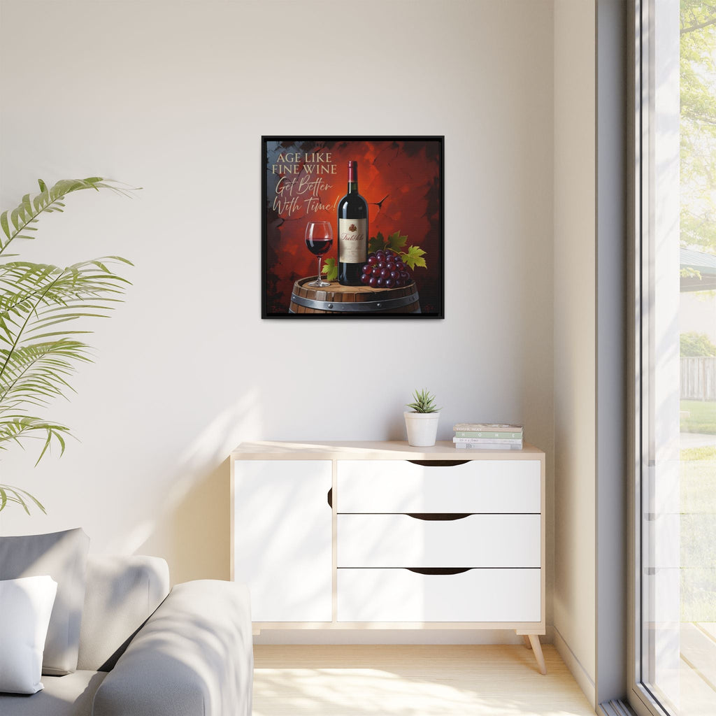 Framed wine rustic decor on a wall above a white cabinet with a plant and books.