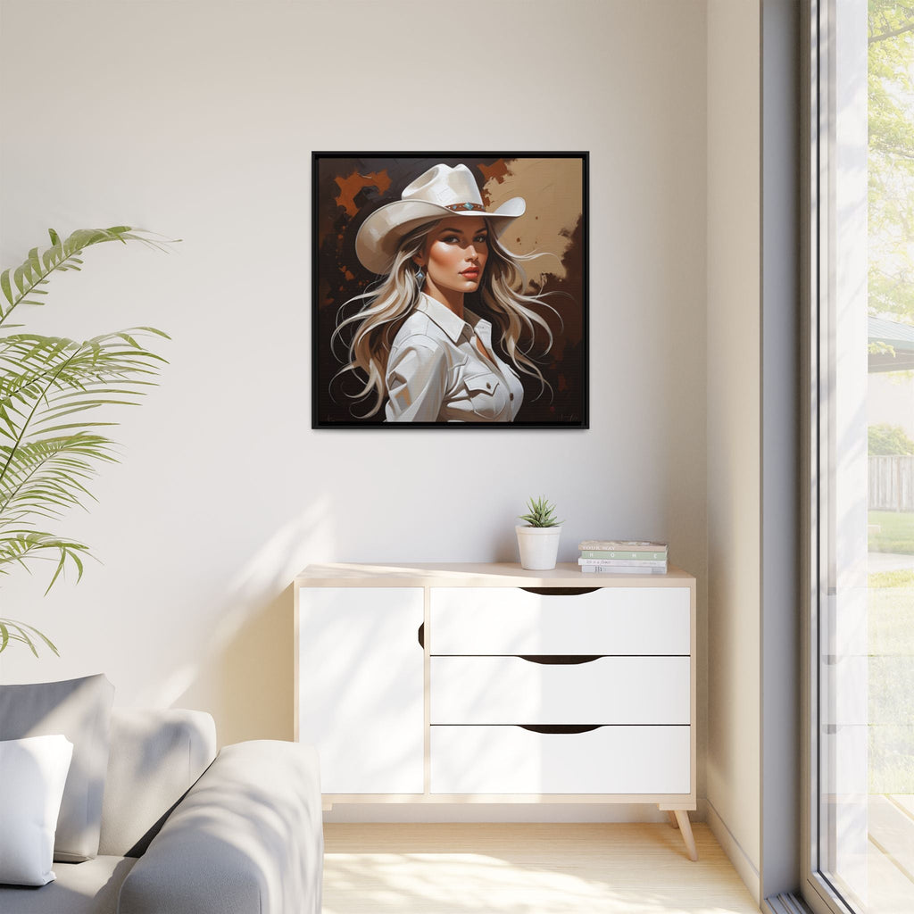 Framed western artwork of a cowgirl in a cowboy hat on a wall above a white cabinet.