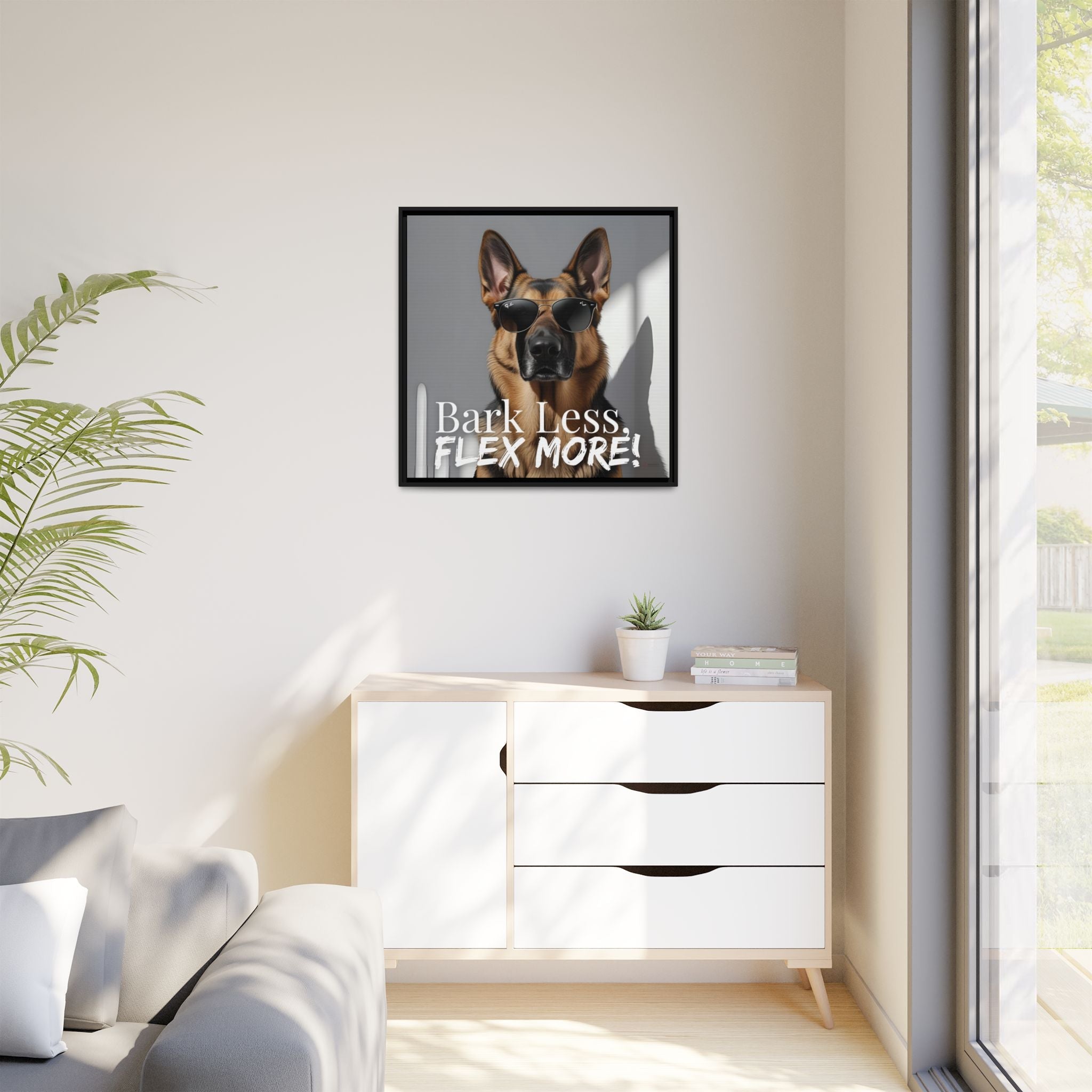 Framed picture of a German Shepard dog with text on a wall above a white cabinet.
