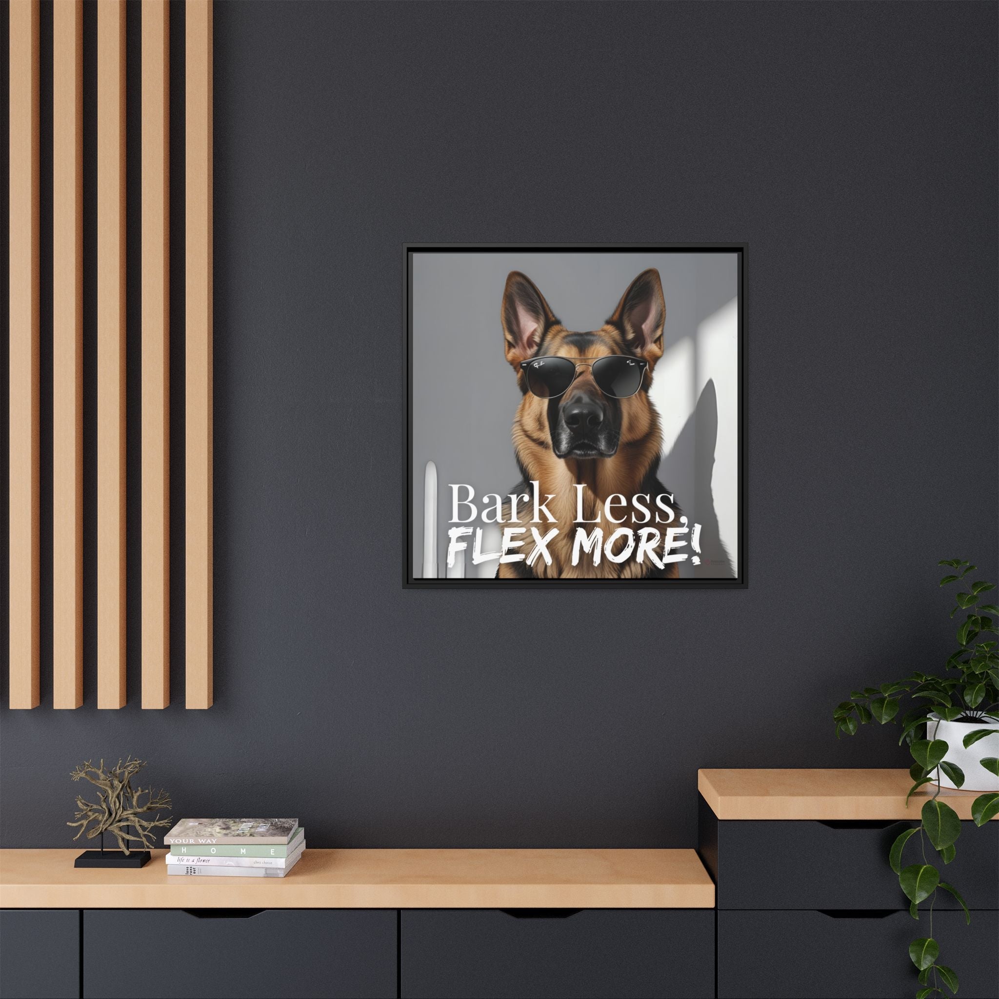 Framed German Shepard wall art with sunglasses and text 'Bark Less, Flex More!' on a dark wall.