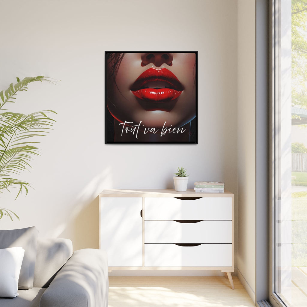 Framed artwork with red lips and text on a wall above a white cabinet.