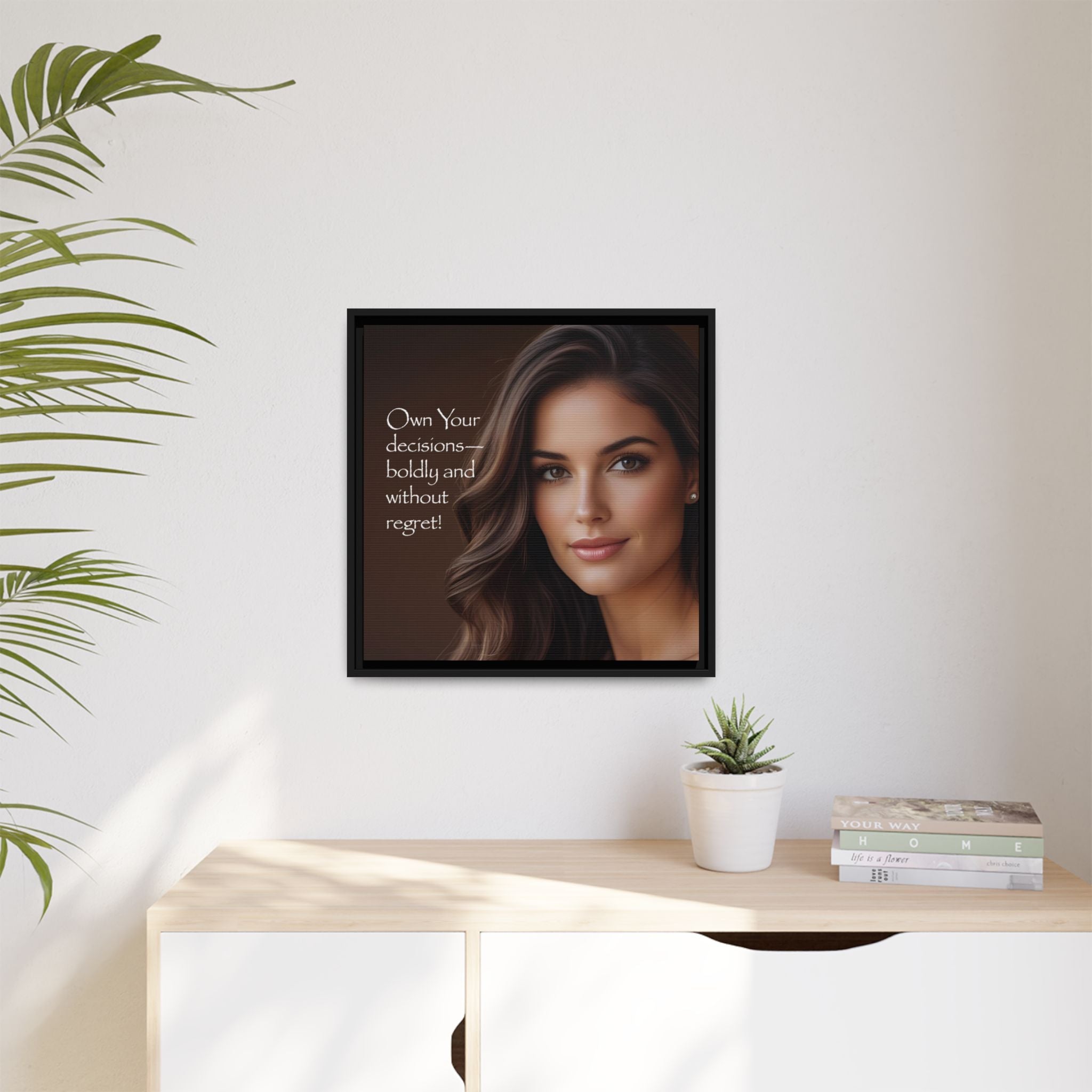 Framed portrait of a woman with motivational quote on a wall above a desk with decor items.