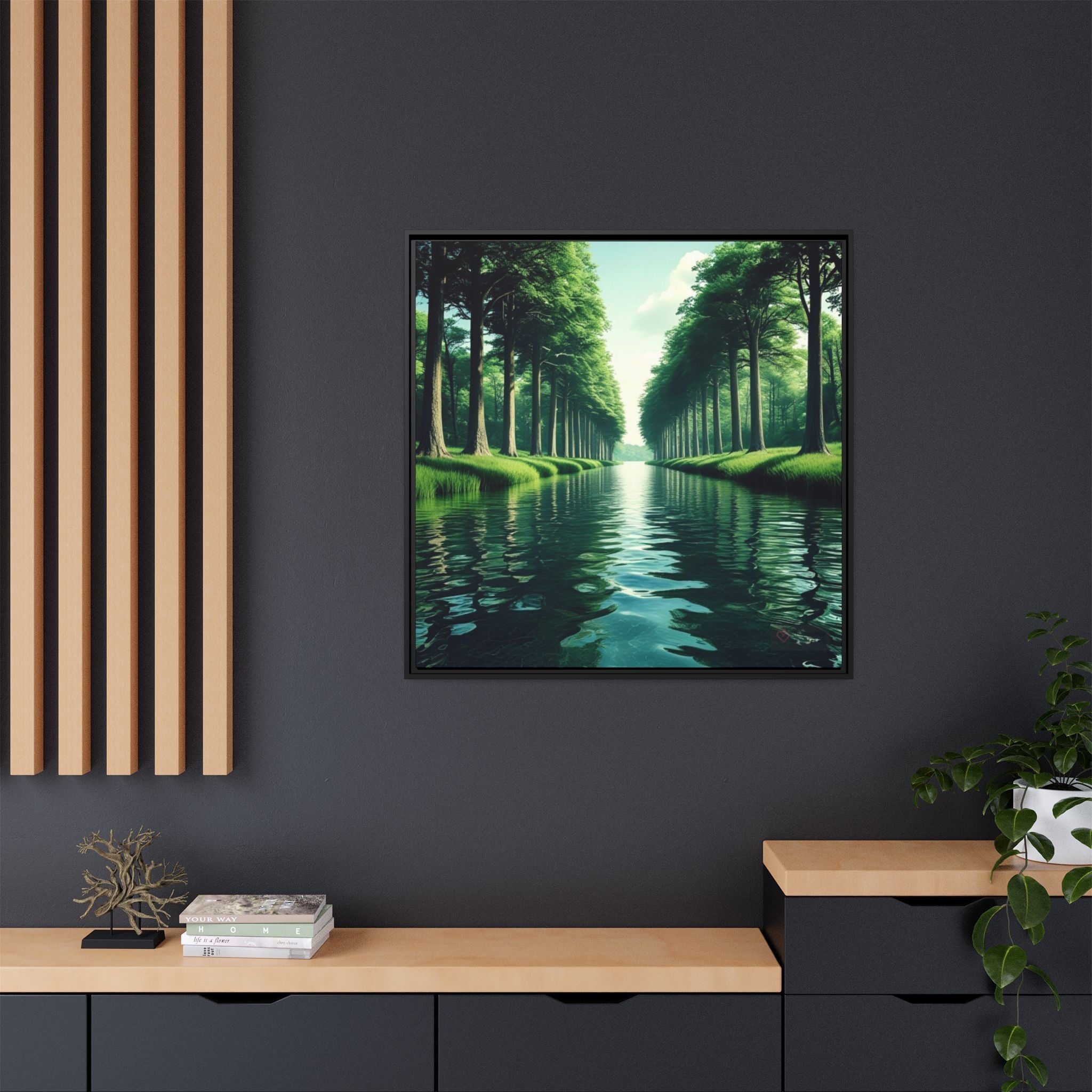 Framed artwork of a scenic nature landscape with trees and water on a dark wall.