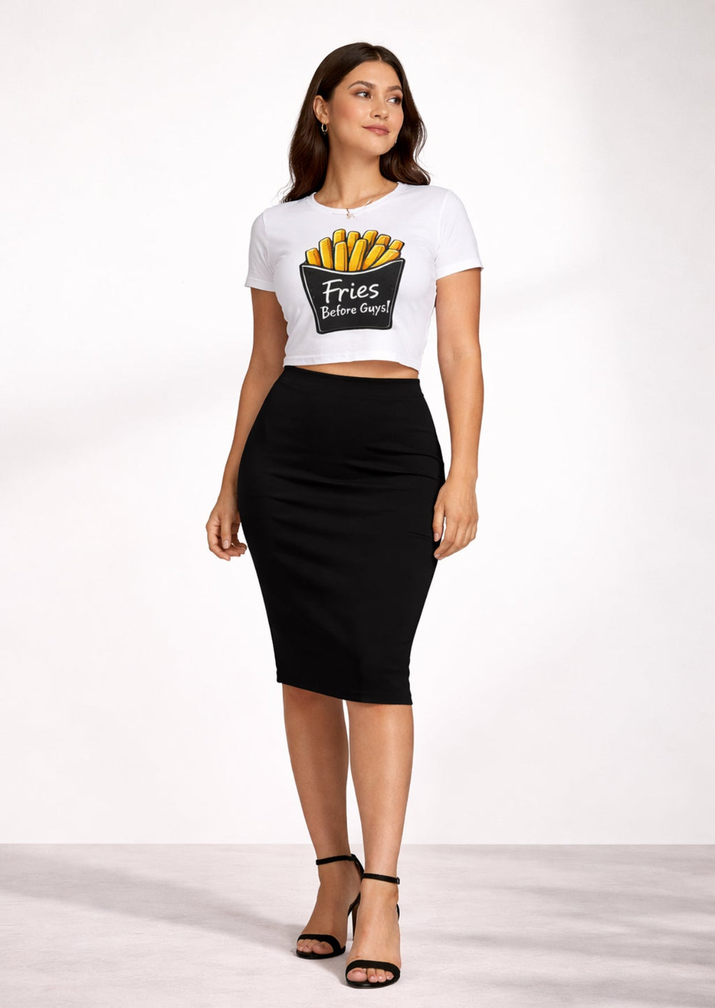 Woman wearing a white t-shirt with a graphic design ‘Fries Before Guys’ and a black skirt on a white background