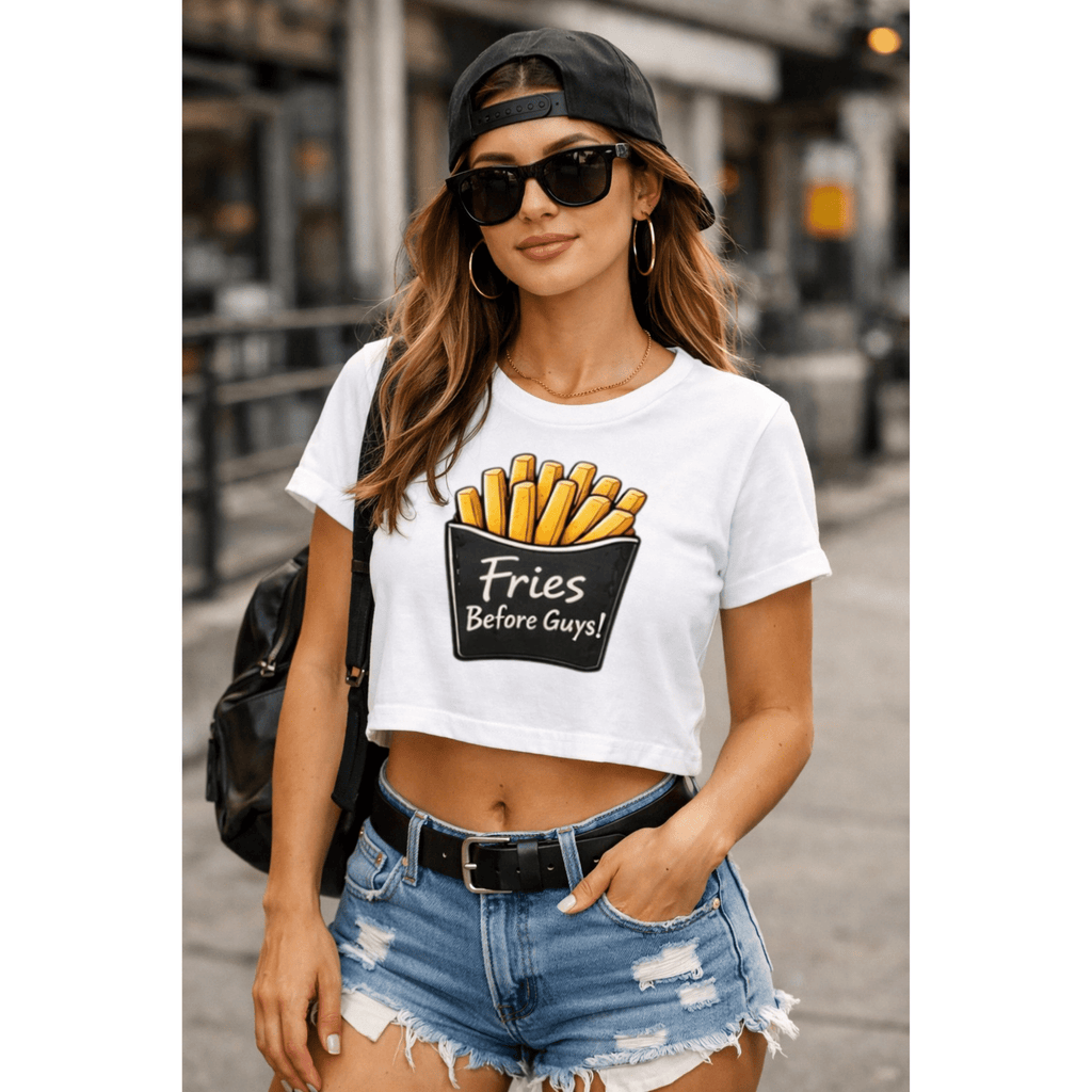 Woman wearing a white t-shirt with a graphic design and text, ‘Fries Before Guys’ standing outdoors.