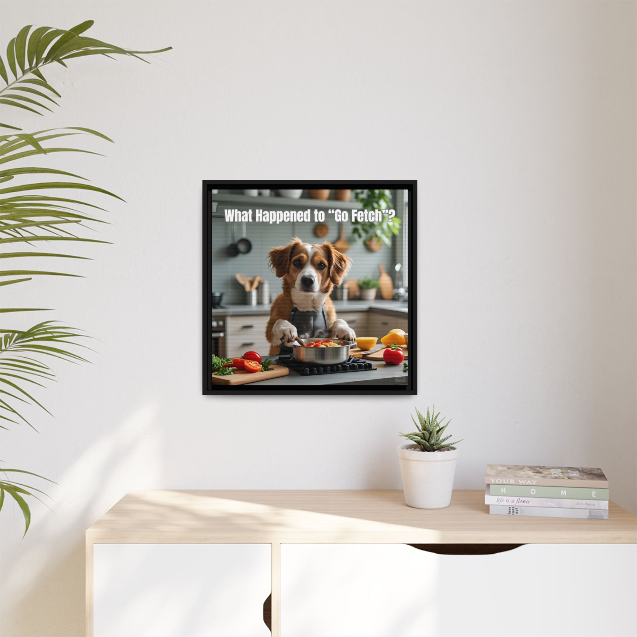 Framed funny picture of a dog in a kitchen cooking with text on a wall above a desk.
