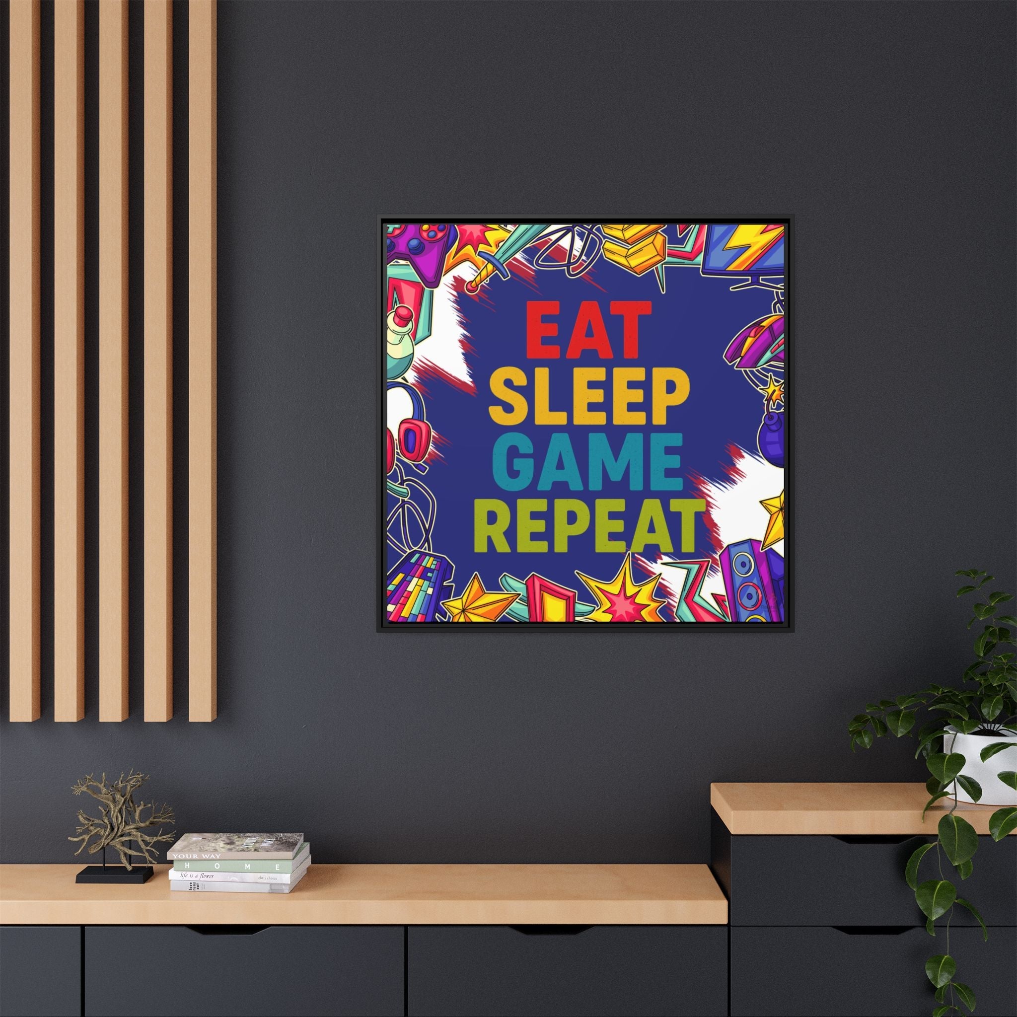 Colorful framed gamer artwork with 'Eat Sleep Game Repeat' text on a dark wall.