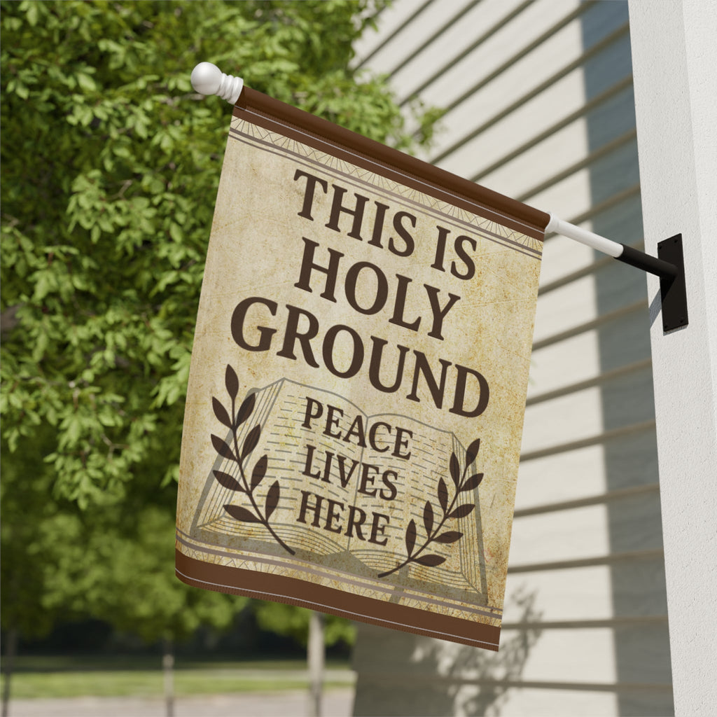Decorative flag with 'This is Holy Ground, Peace Lives Here' text on a house exterior.