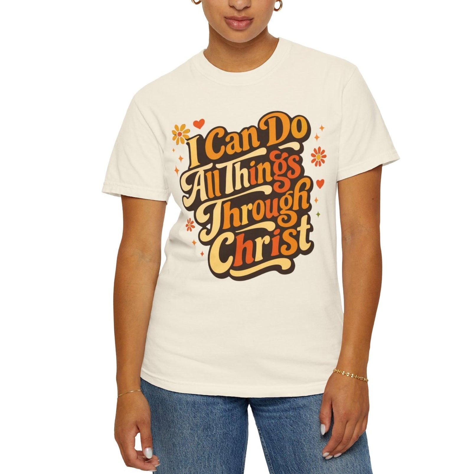 Person wearing a beige t-shirt with motivational quote 'I Can Do All Things Through Christ' on a plain white background 