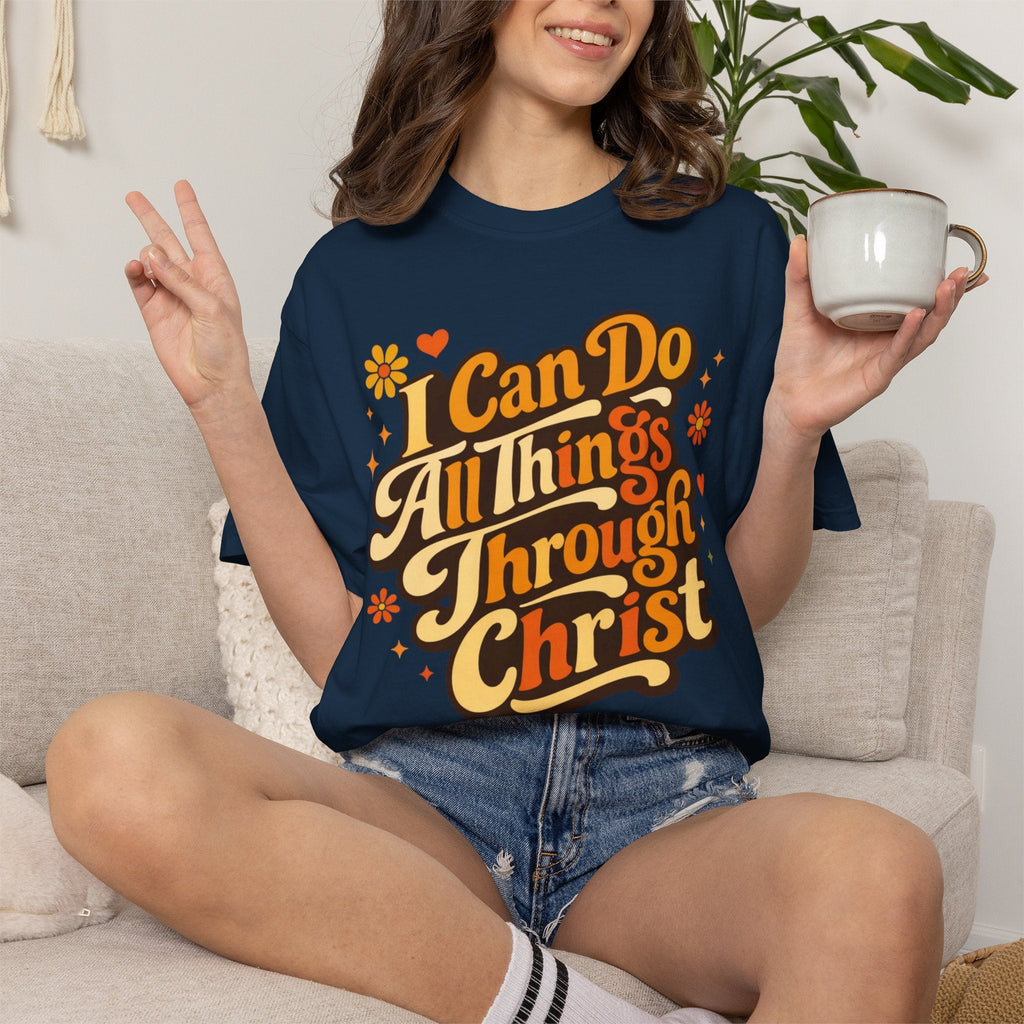 Woman wearing a navy blue t-shirt with inspirational quote, holding a mug in a casual setting.