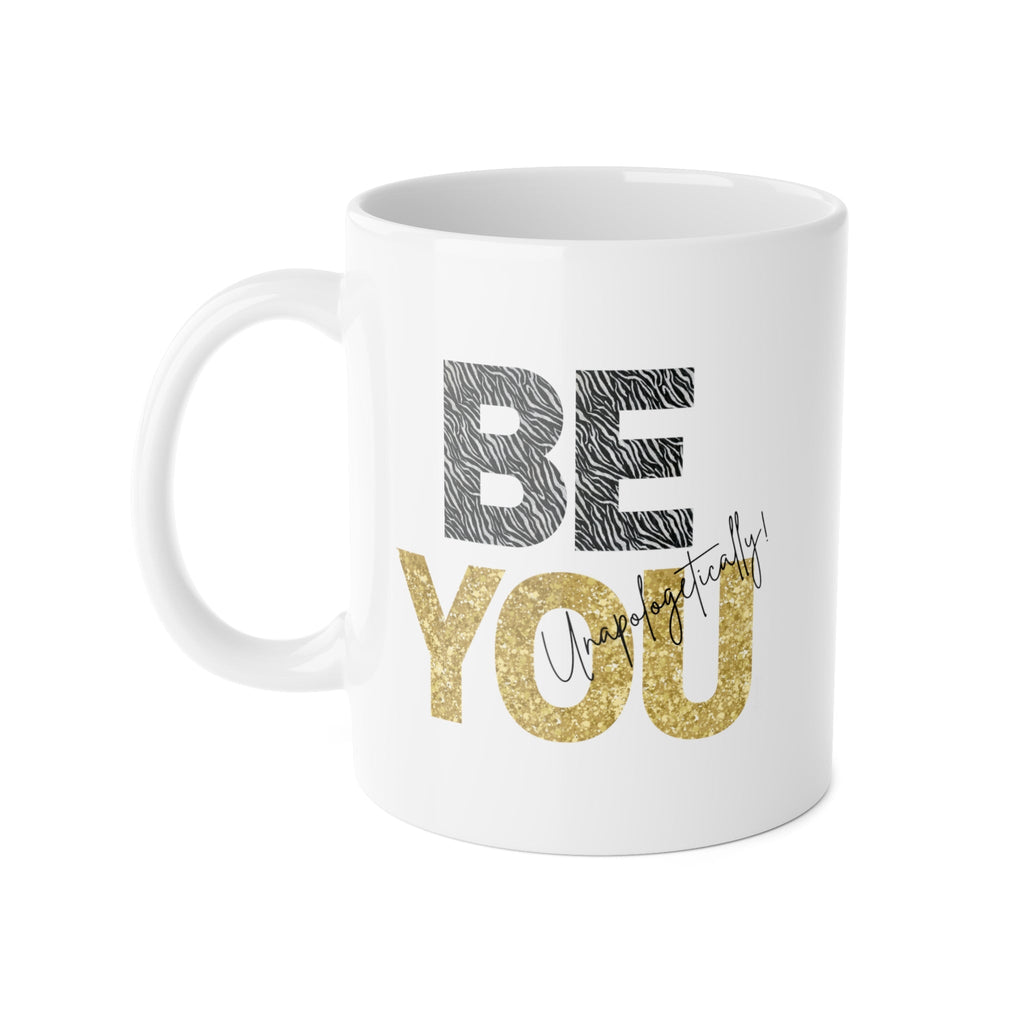 White mug with quote 'Be You - Unapologetically' in tiger stripes and gold lettering - confident modern design