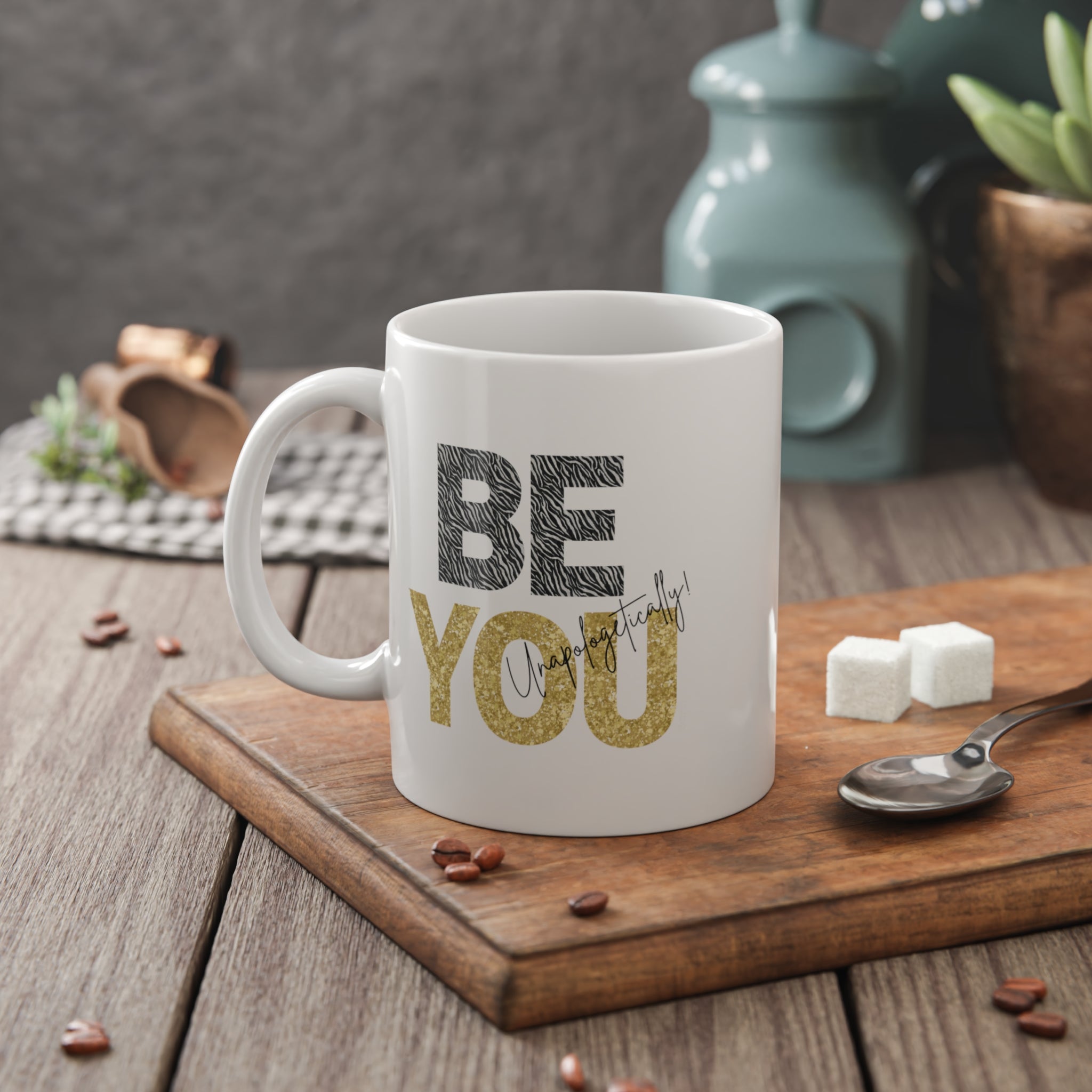Inspirational 'BE YOU' White mug with text on a wooden cutting board with coffee beans and sugar cubes.