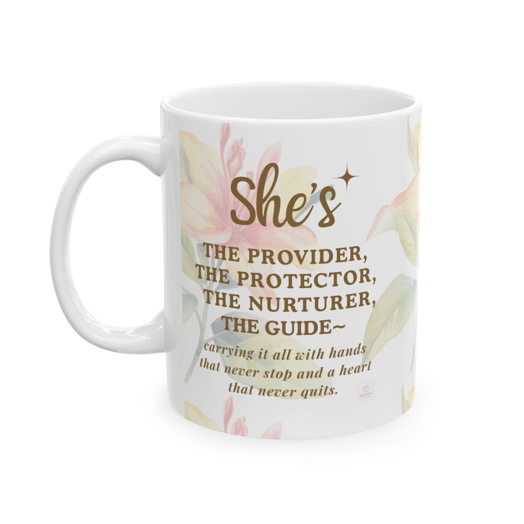 Close-up of “She’s the Provider” text on ceramic mug with soft floral background