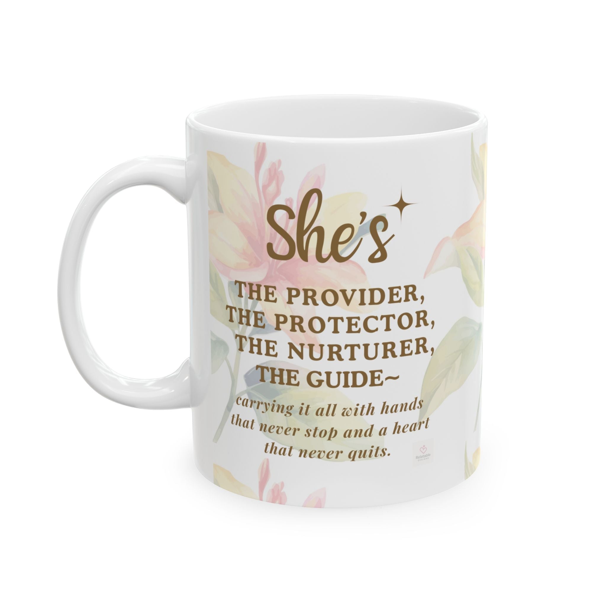 Close-up of “She’s the Provider” text on ceramic mug with soft floral background