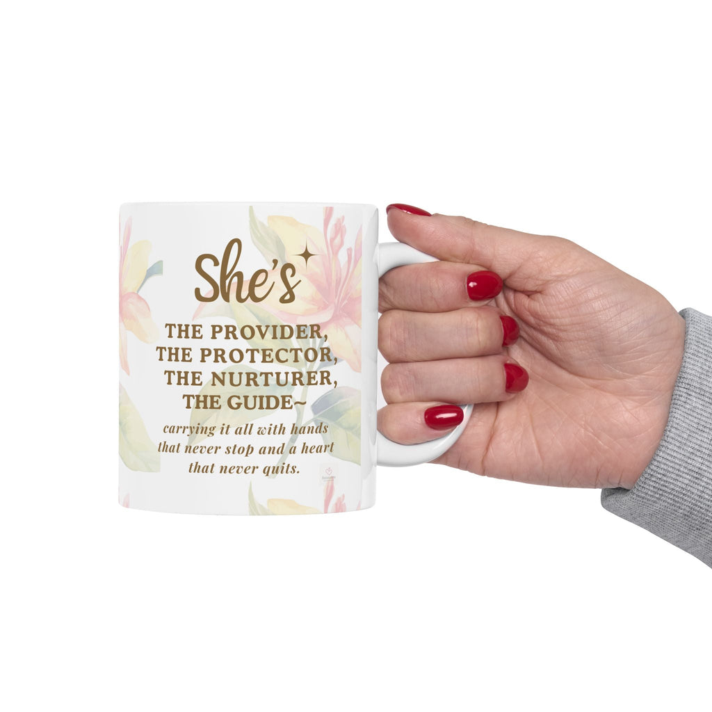 Hand holding motherhood quote mug with floral design and meaningful message