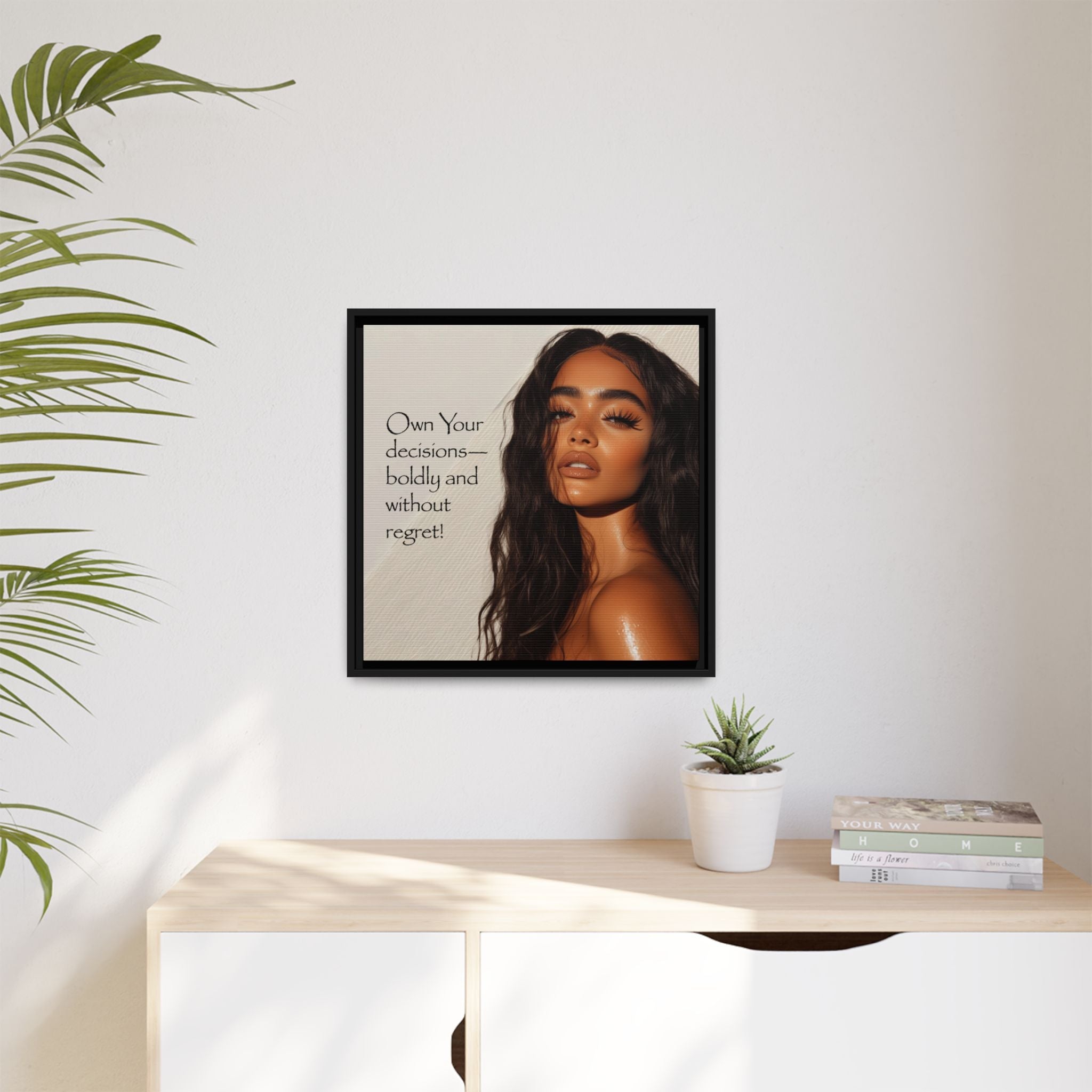 Framed canvas portrait of a Latino woman with motivational quote on a wall above a desk with decor items.