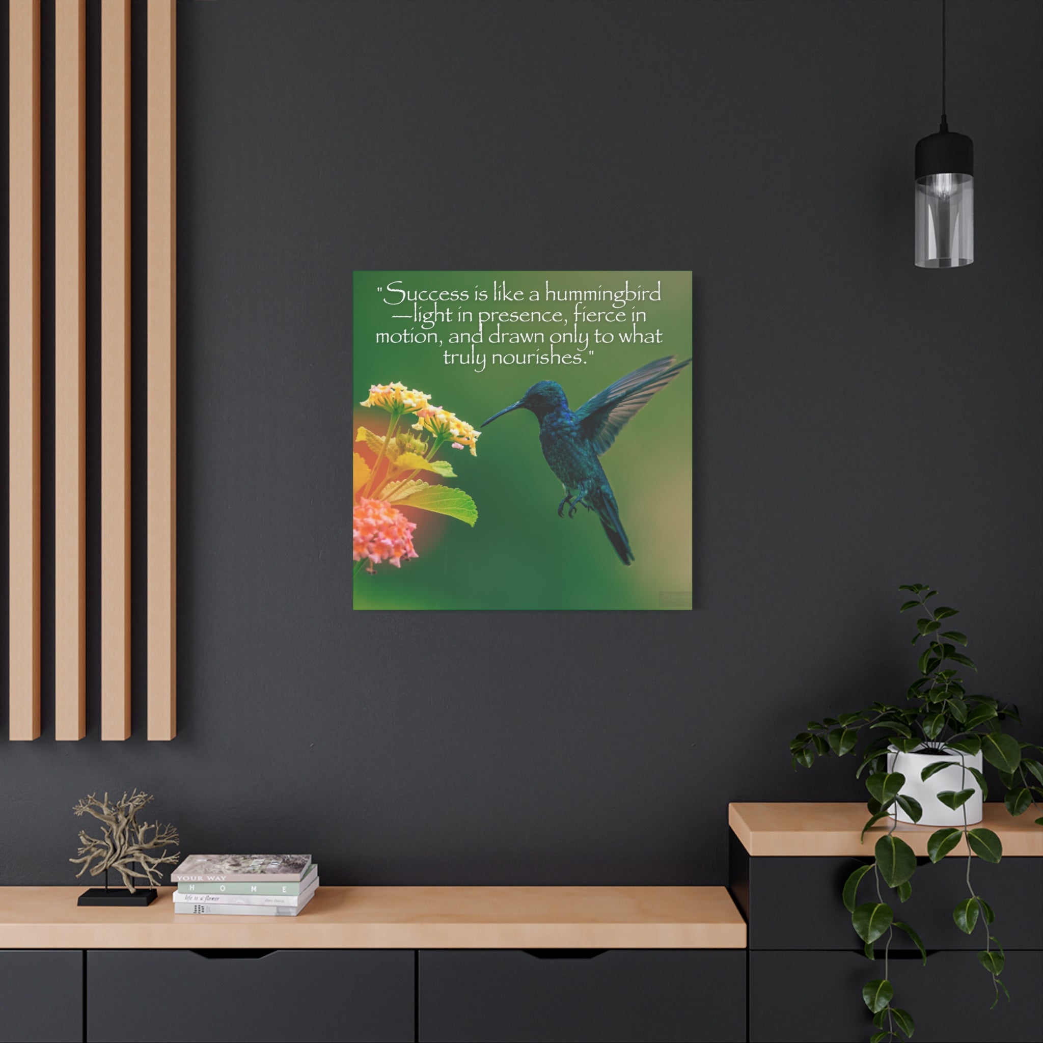 Framed artwork of a blue hummingbird and yellow flowers on a dark wall with decor elements.