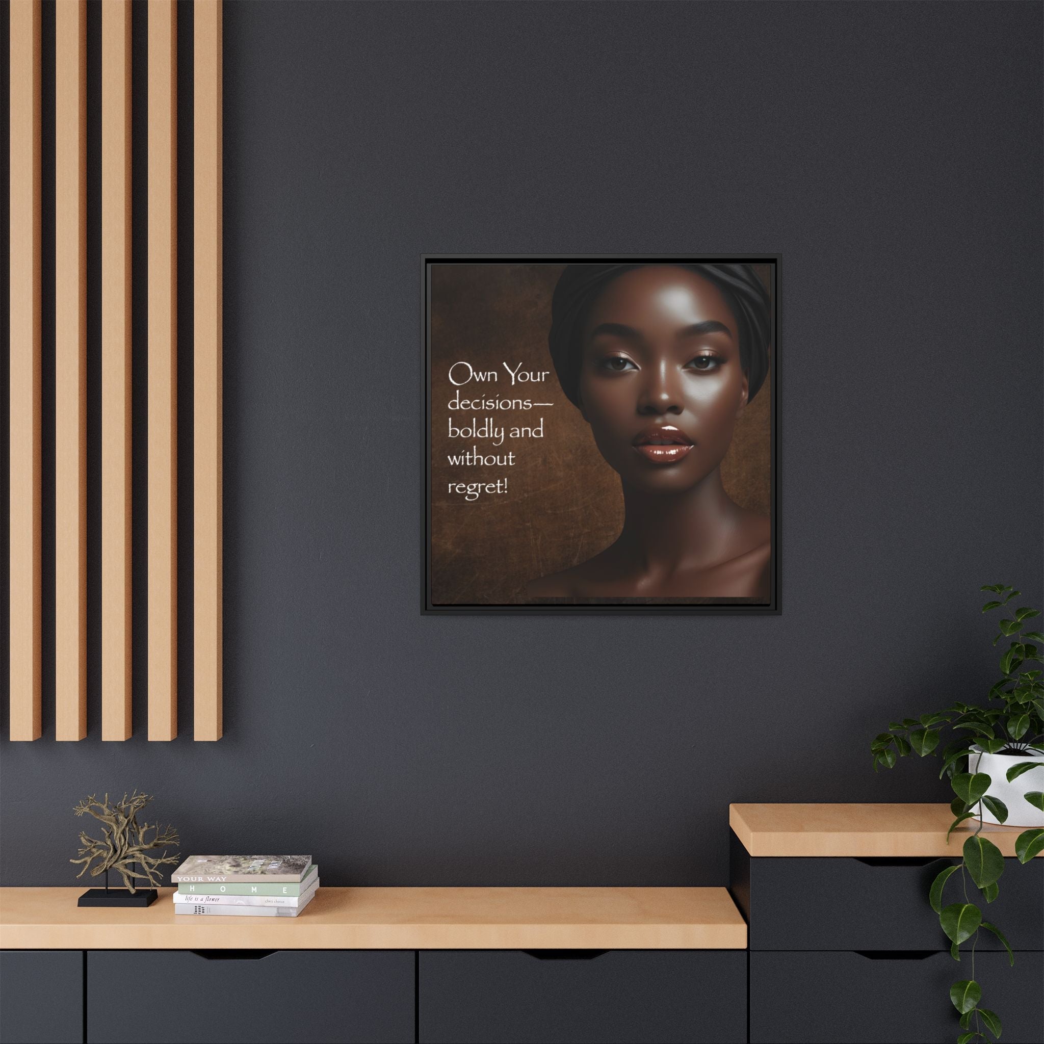 Framed artwork of a woman's portrait with inspirational quote on a dark wall.