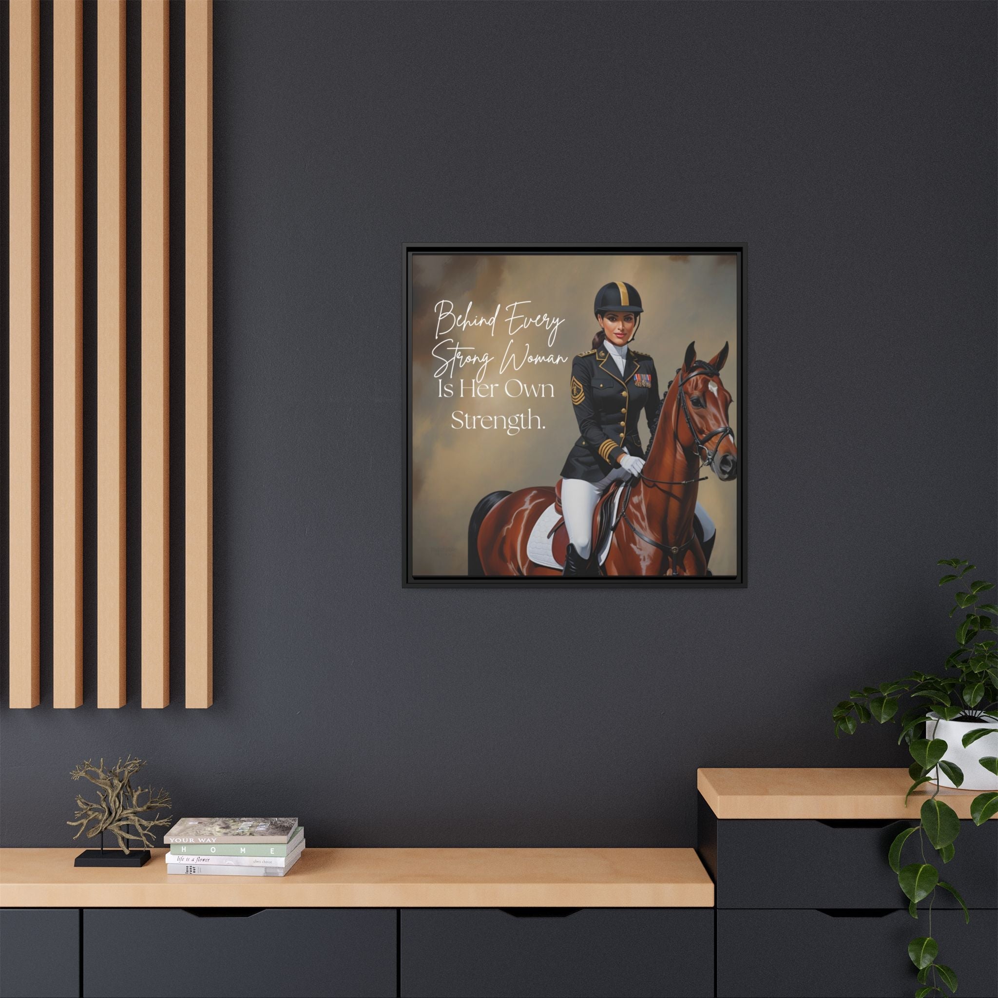 Framed artwork of a woman on horseback with inspirational text on a dark wall.