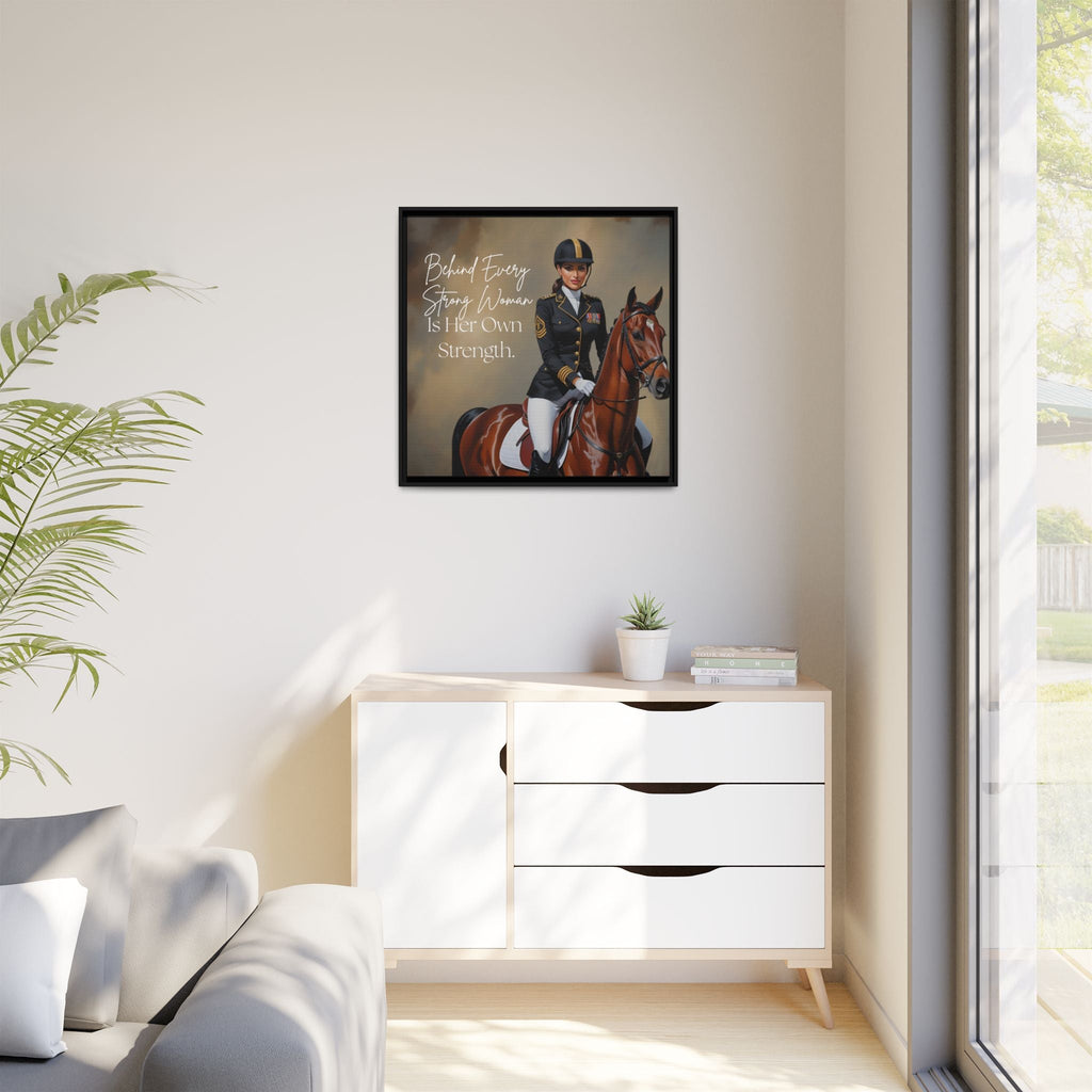 Framed picture of a person on a horse with a quote above a white cabinet in a room with a plant and window.