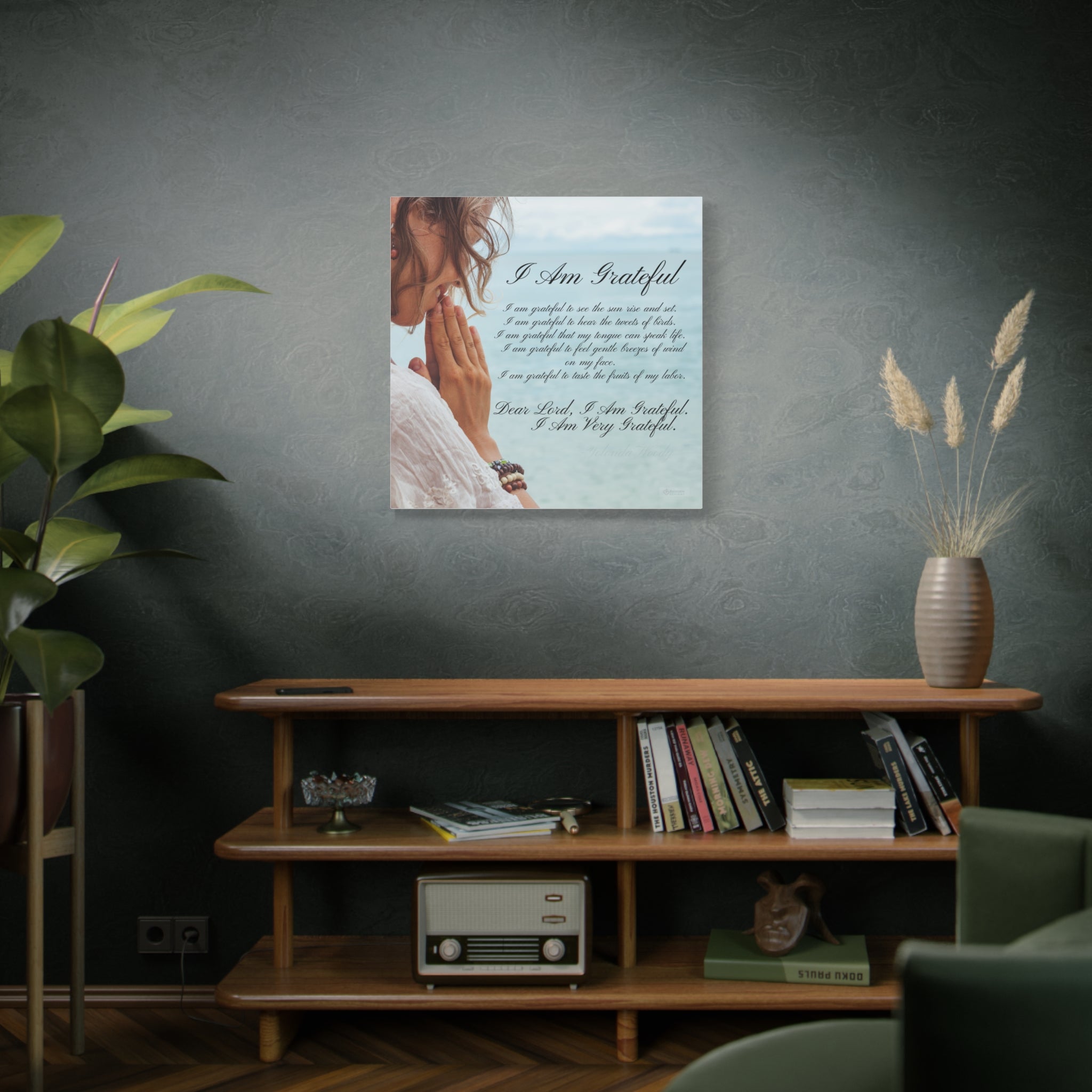 Motivational Framed artwork and quote on a dark wall above a wooden shelf with books and decor.