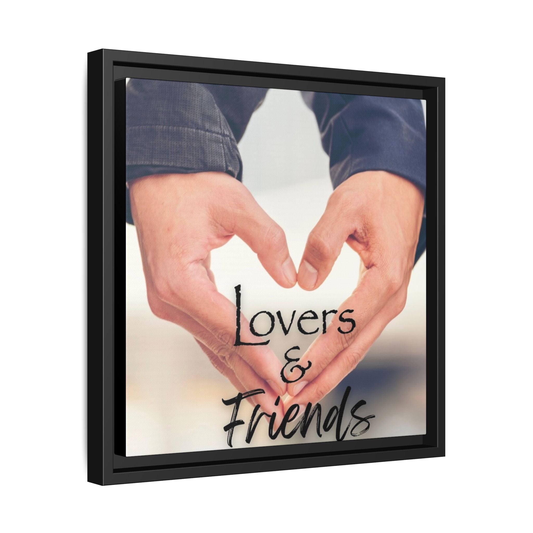 Framed artwork of male hands forming a heart shape with text 'Lovers & Friends' below.  Side View.