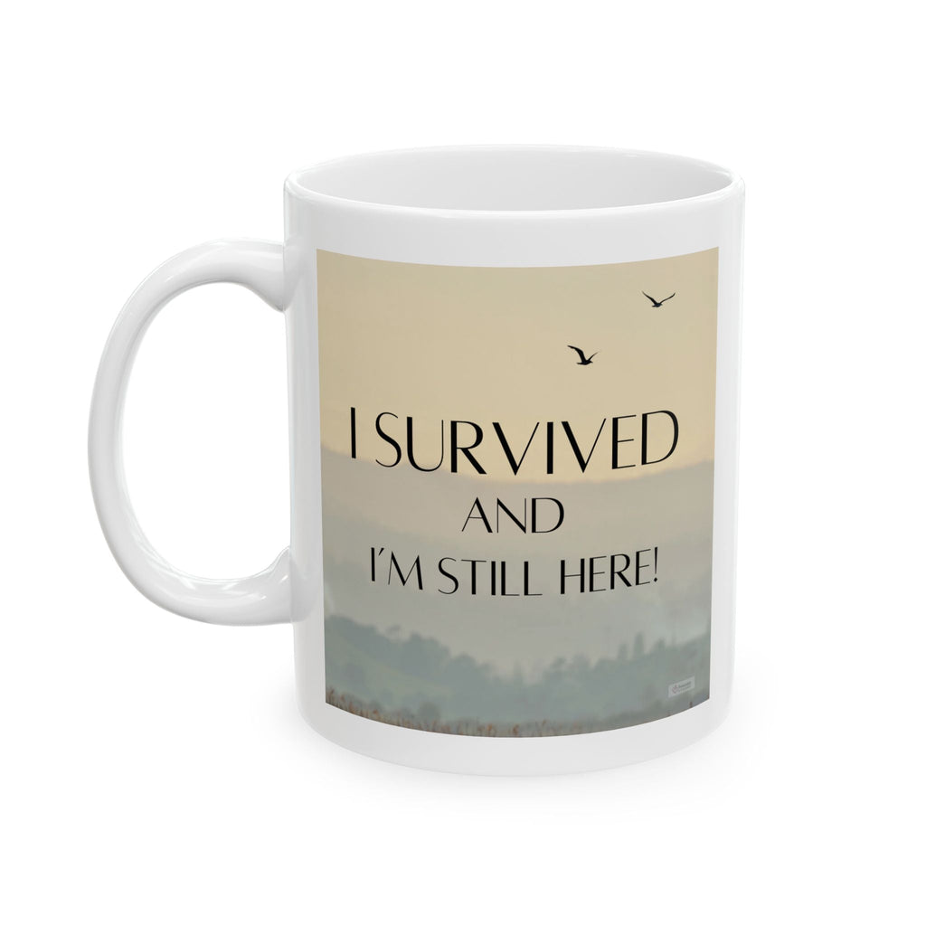 White mug with 'I survived and I'm still here!' text and a scenic design on a white background. Left View