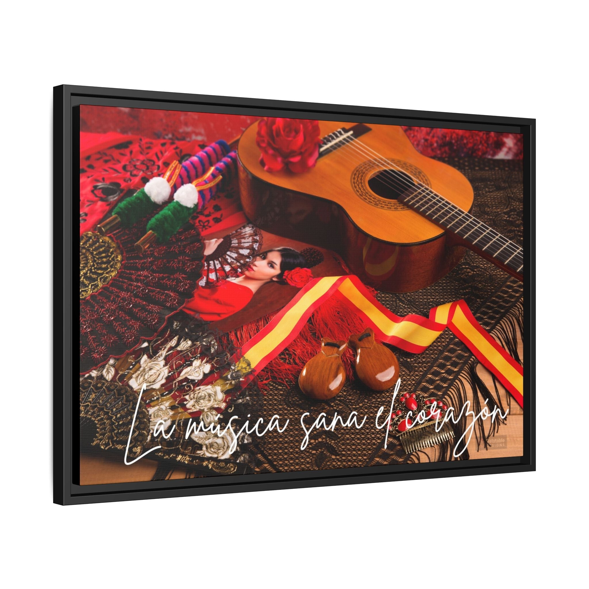 Framed artwork with a guitar, colorful ribbons, and text on a red background.